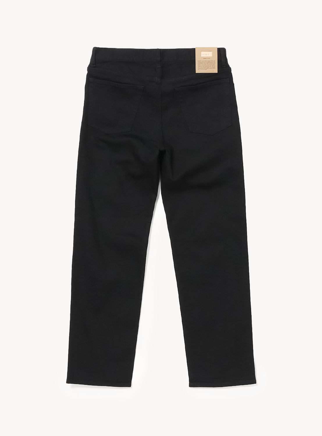 Back view of black BEAMS Comfy 5-Pocket Denim slim fit jeans with a tan leather brand patch on the back waistband.