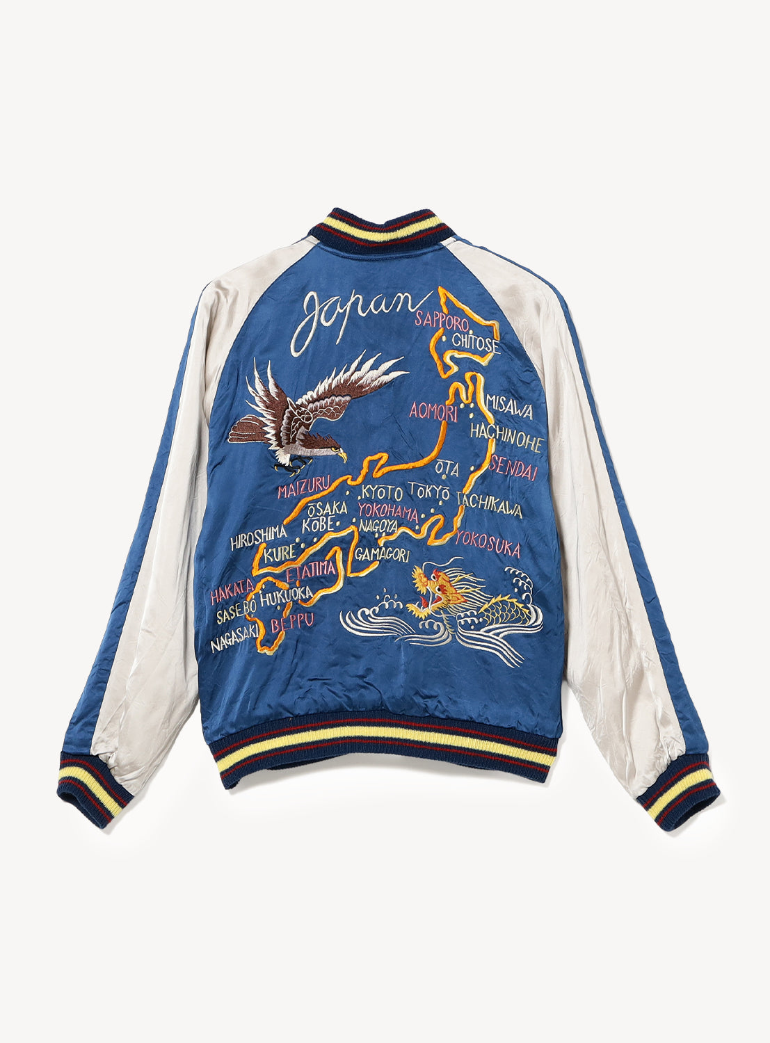 The TAILOR TOYO Late 1940s Style Acetate Souvenir Jacket KOSHO & CO. Special Edition “EAGLE & DRAGON” × “JAPAN MAP” features Japan embroidery, a map, city names, eagle and tiger designs in bold blue and white with striped cuffs, collar, and waistband.