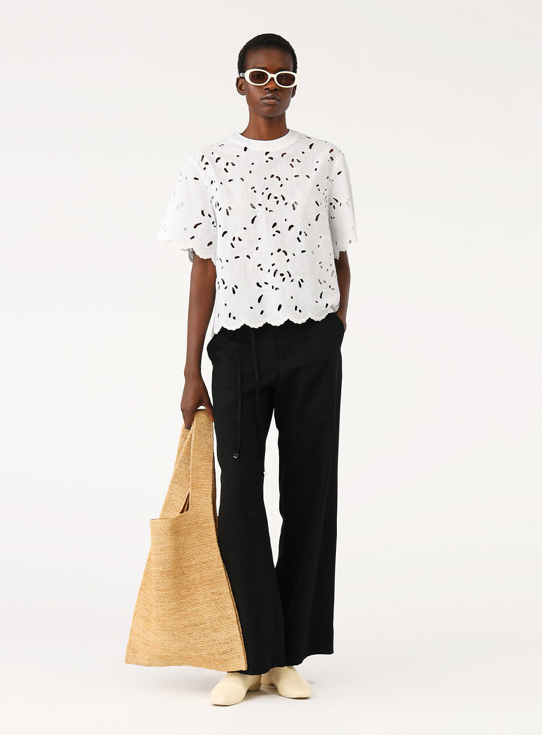 Model wearing a white blouse, showcasing the elegant and relaxed shape and sophisticated presence.