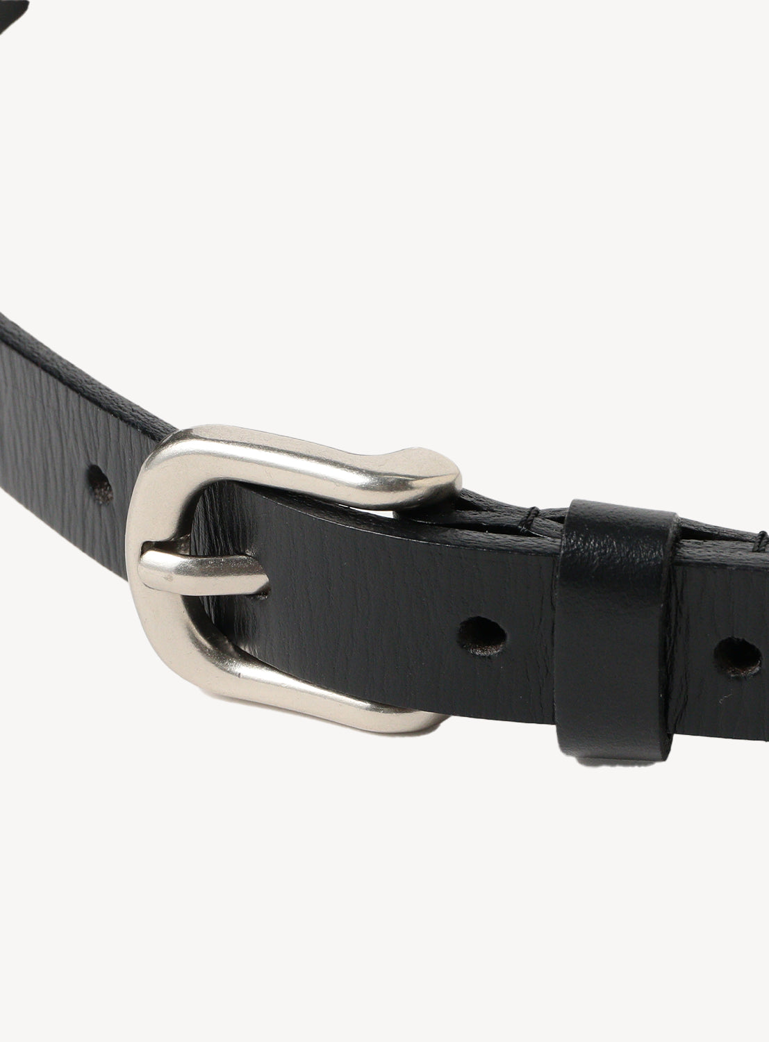 Close-up of a black leather belt, detailing the rectangular brass buckle and precise sizing holes.