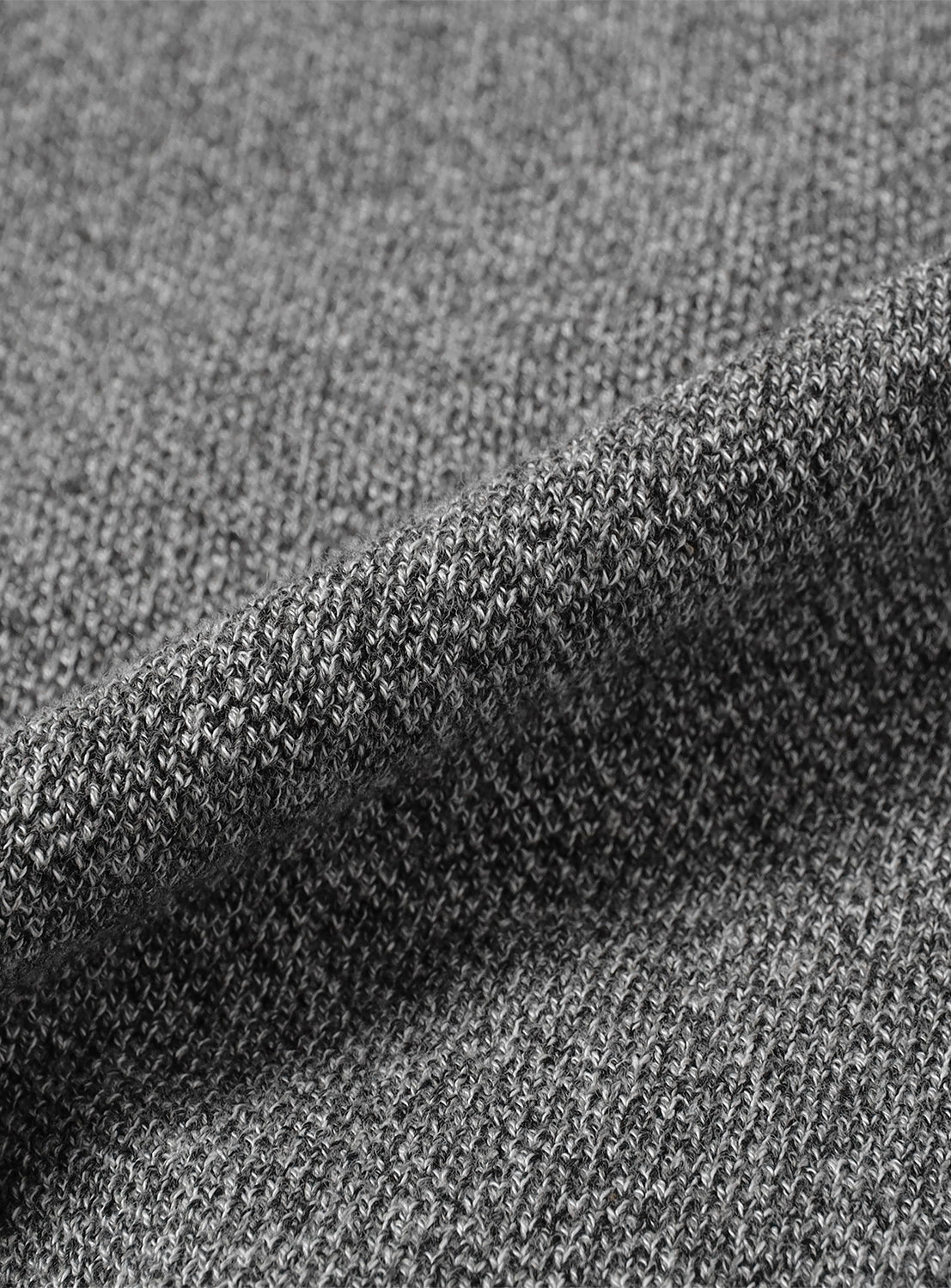 Close-up of dark grey knit fabric, showing a textured weave. 