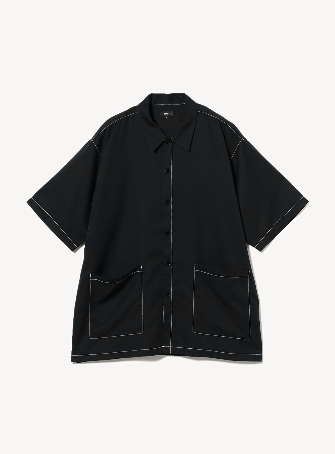 Flat lay of the BEAMS Stitching Easy Shirt in black, featuring a minimalist design with subtle, color-coordinated stitching and an oversized waist pocket. 