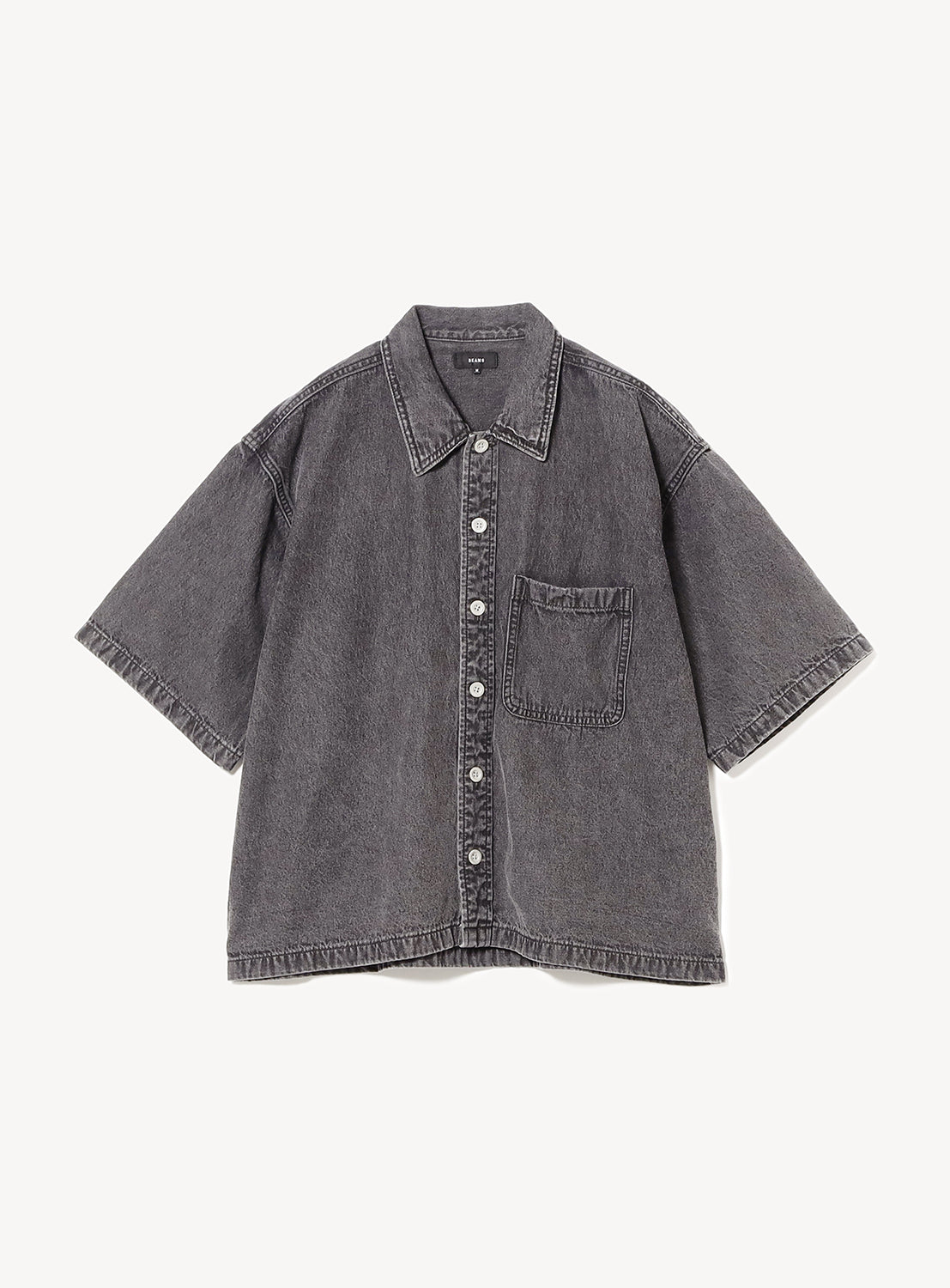 Flat lay of BEAMS Short Denim Shirt in black denim with open camp collar, short sleeves, oversized chest pockets, and relaxed boxy fit.