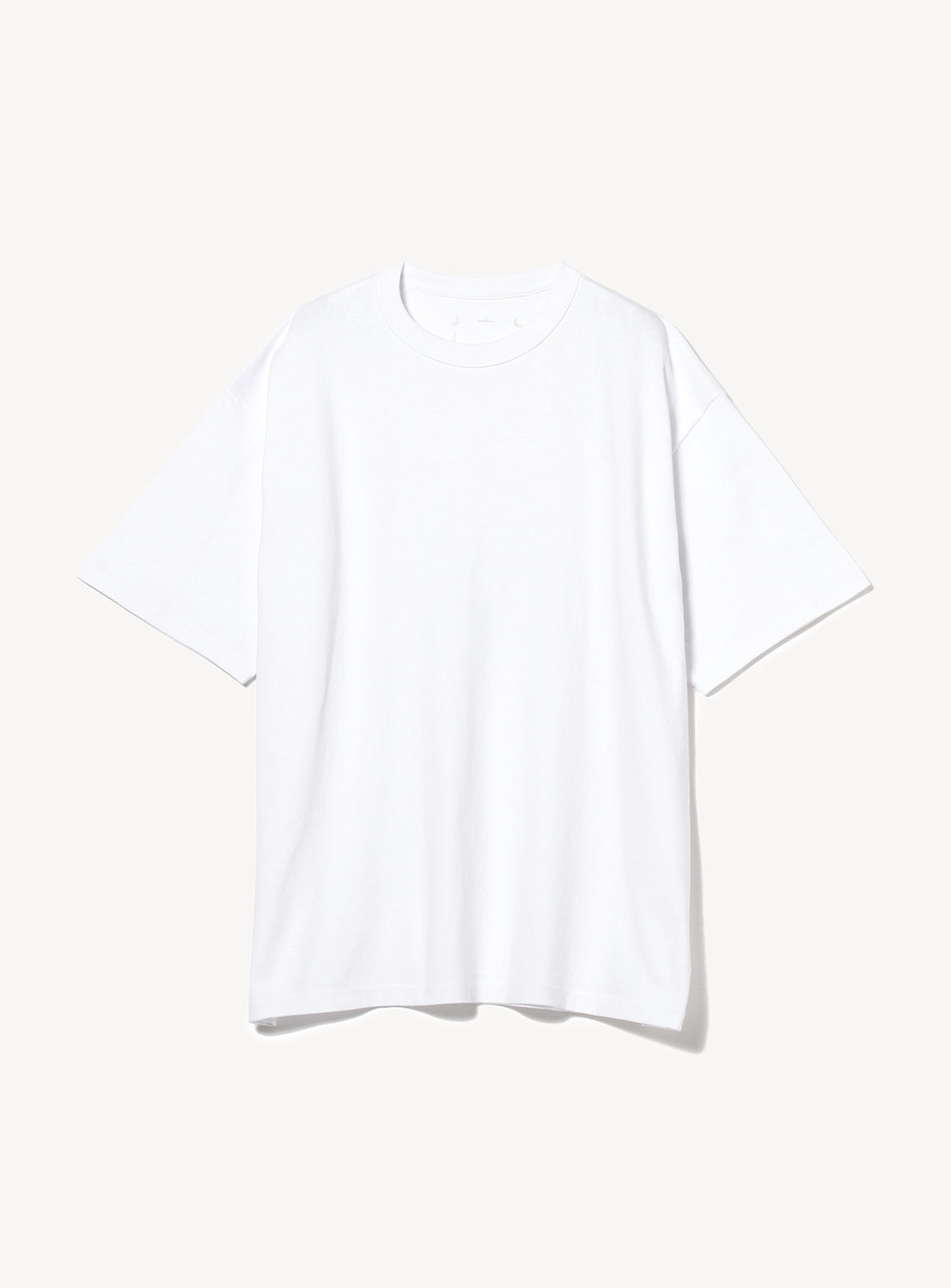 Detailed view of a comfortable white oversized cotton t-shirt with a classic crew neck.