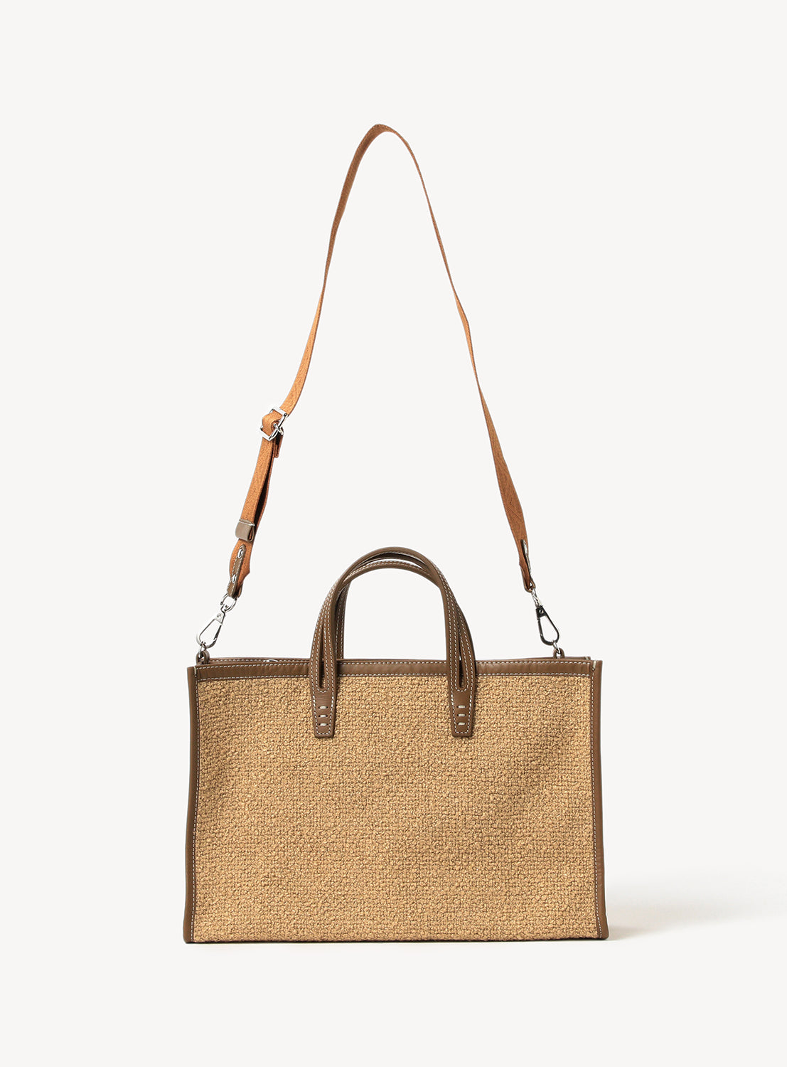 Sandy brown textured tote bag with brown  trim, handle straps and a shoulder strap. 