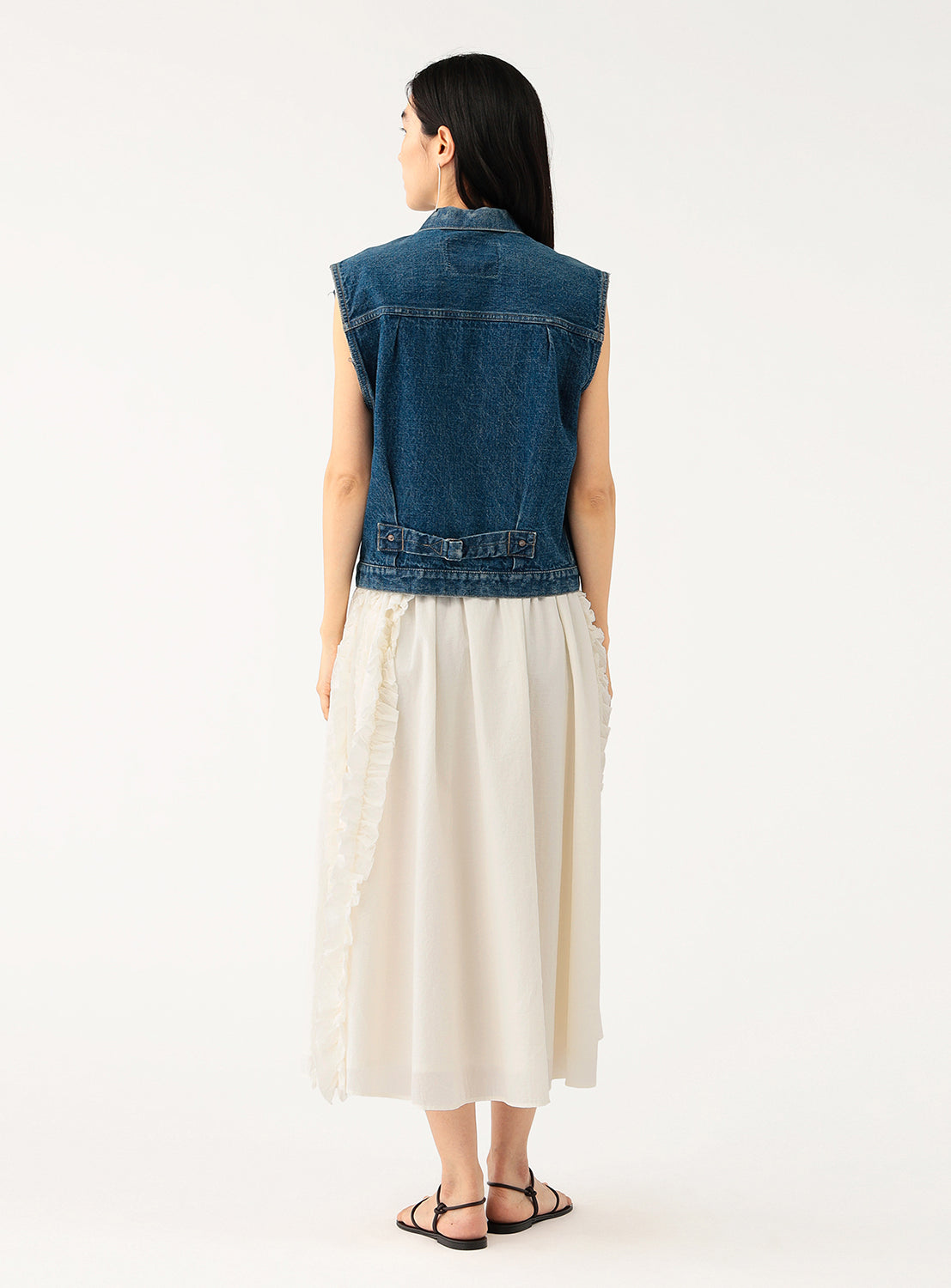 Back view of a model in the white skirt, highlighting the elastic waist and full silhouette.