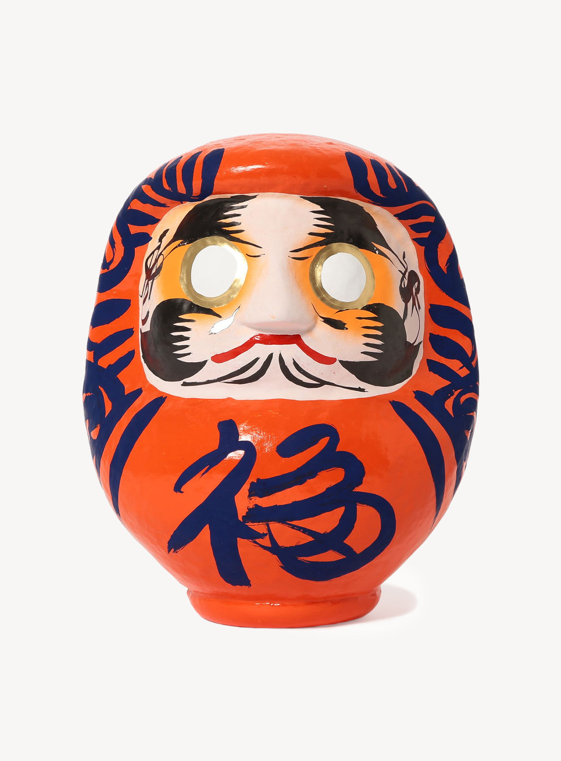 Traditional Japanese daruma doll with a face design on an orange background