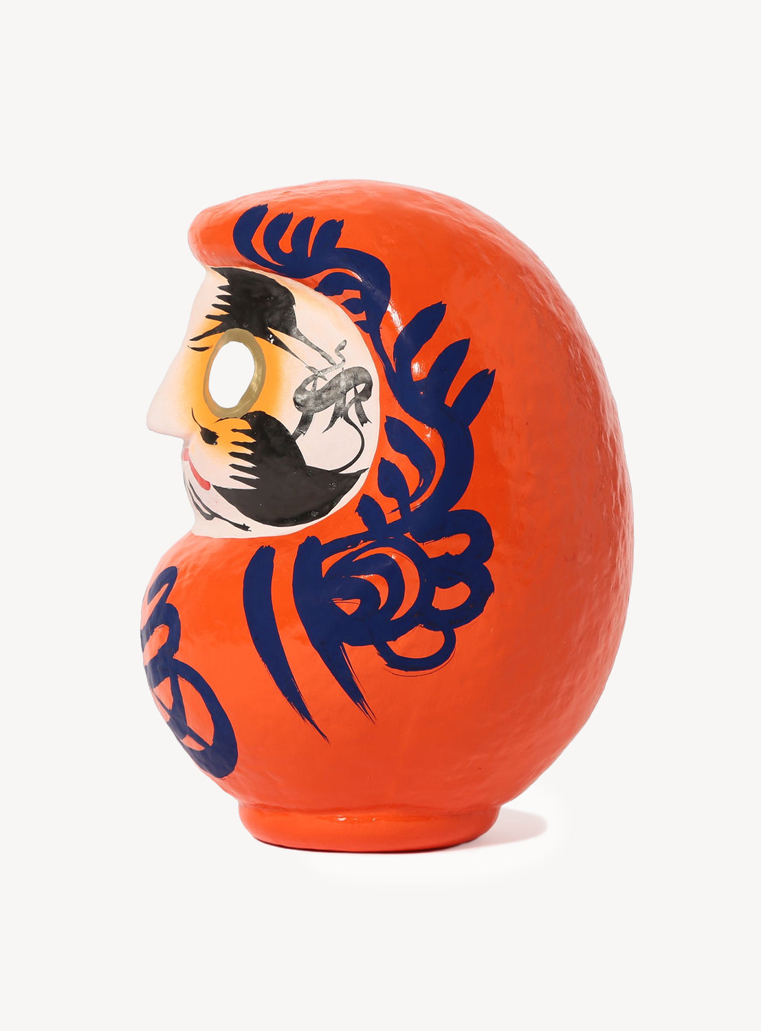 Decorative object with a face design on an orange background