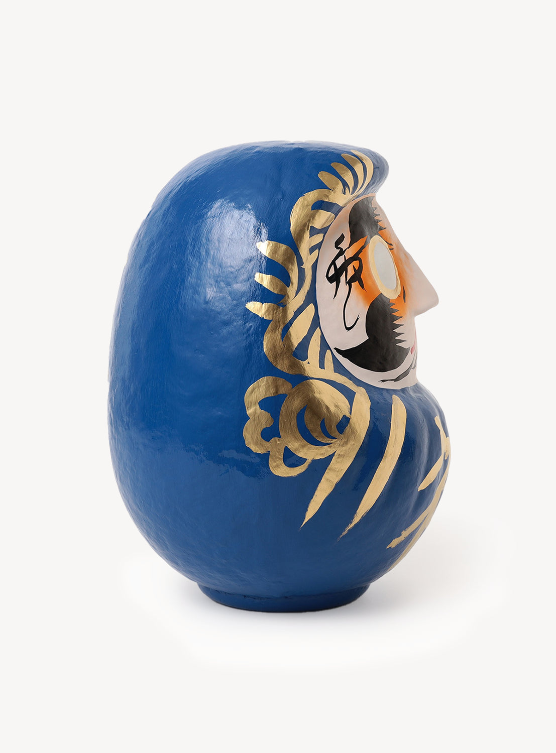 An [Exclusive] BEAMS JAPAN Large Shirakawa Daruma LA by BEAMS JAPAN, this blue, round Daruma doll with gold painted accents features a profile face complete with mustache, beard, and a prominent pointed nose—expertly crafted to highlight exquisite Japanese artistry against a white background.