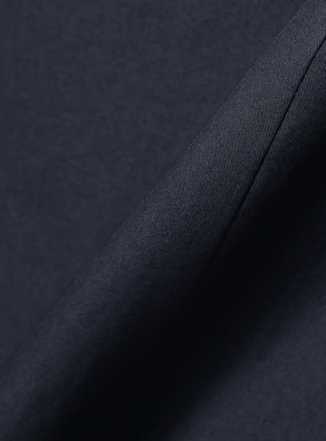Up-close texture shot of the deep blue dress material, emphasizing its quality.