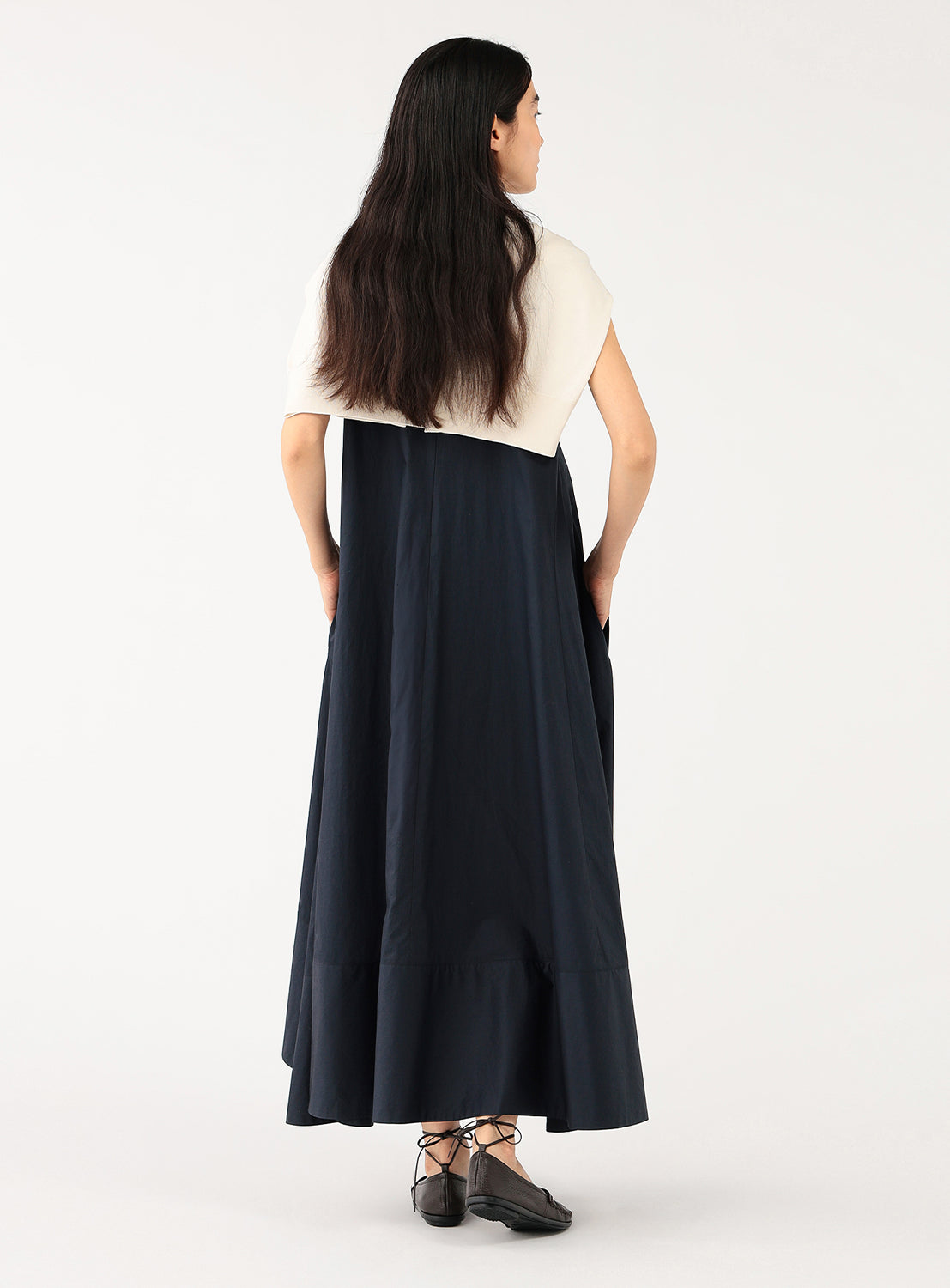 Detail shot of the skirt portion of the dark blue dress, showing the drape and full A-line shape.