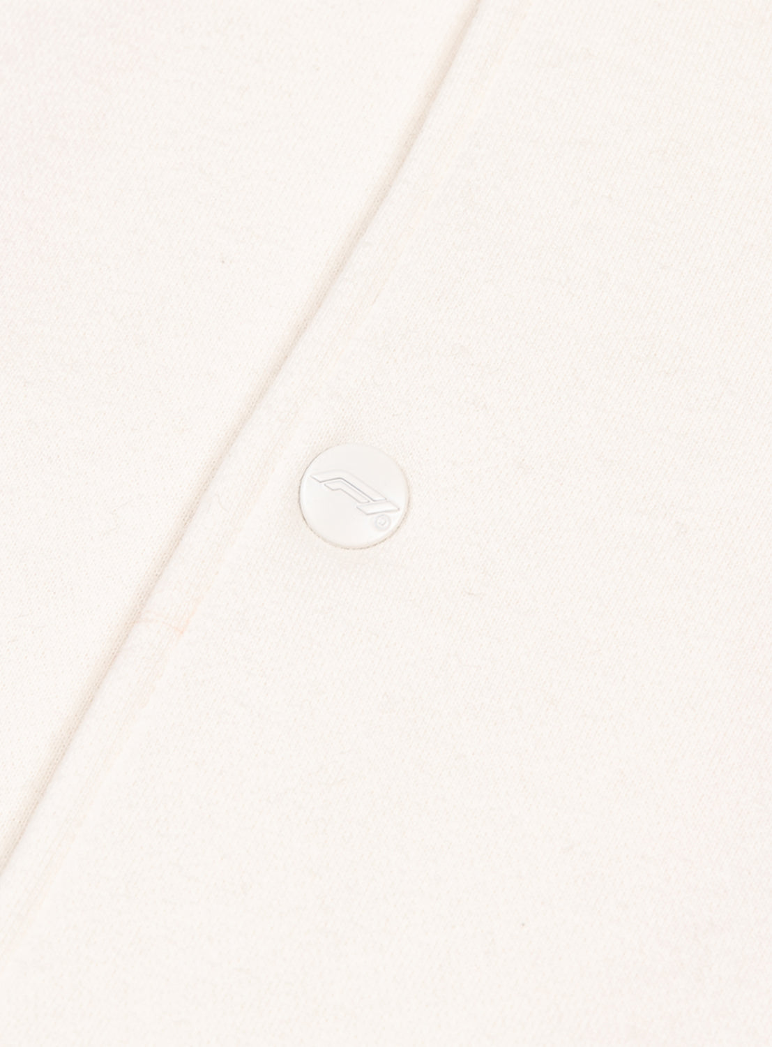Close up of the varsity jacket and the button detail. 