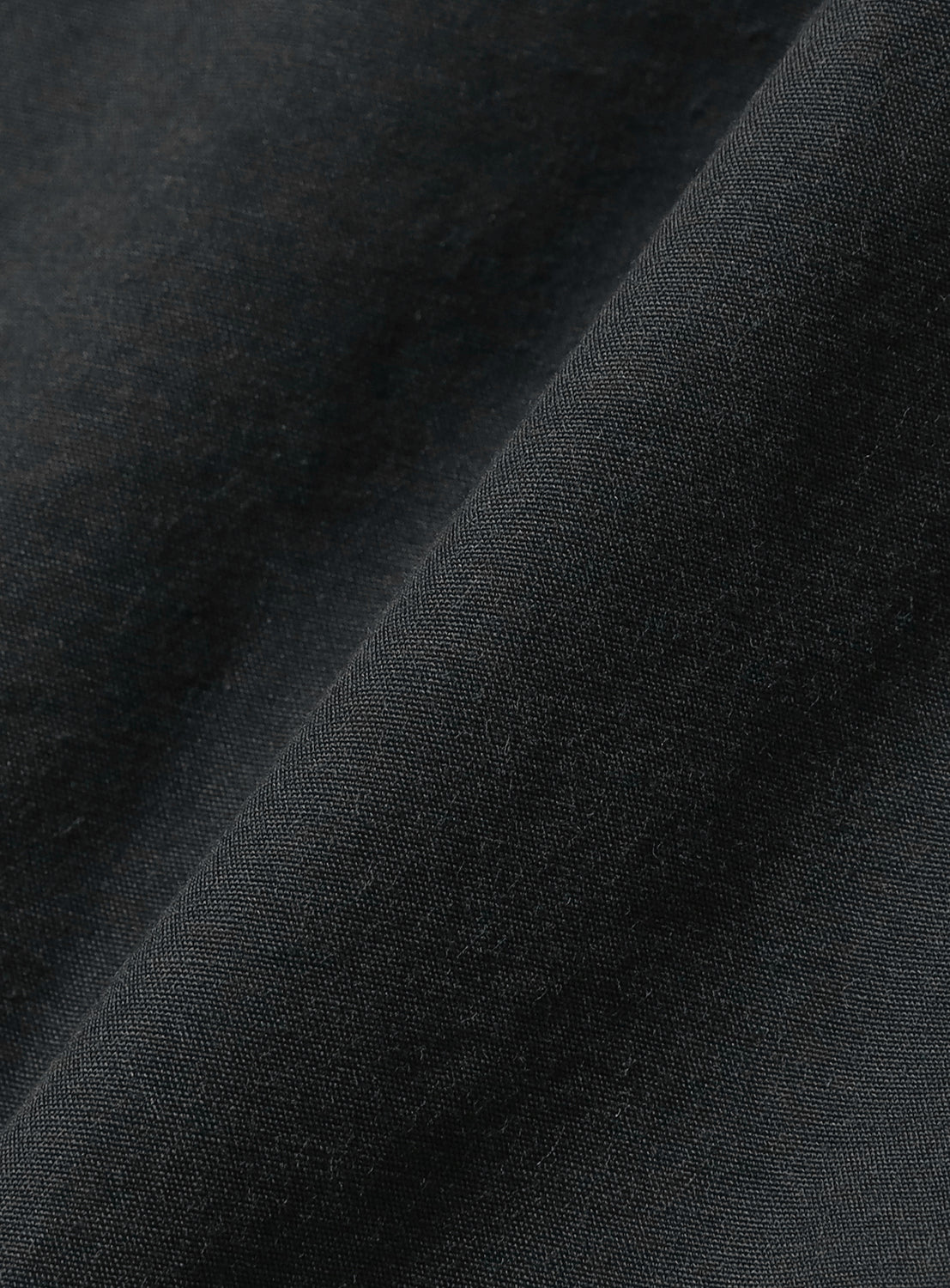 Black fabric, revealing a soft, textured weave.