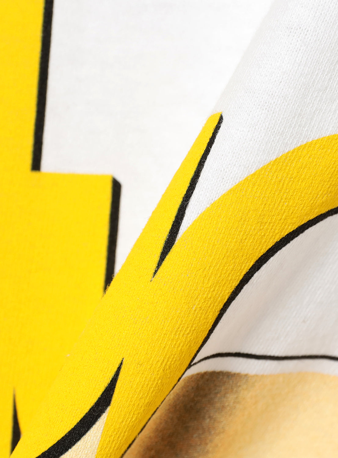 Close-up of a white long sleeve shirt and yellow text. 