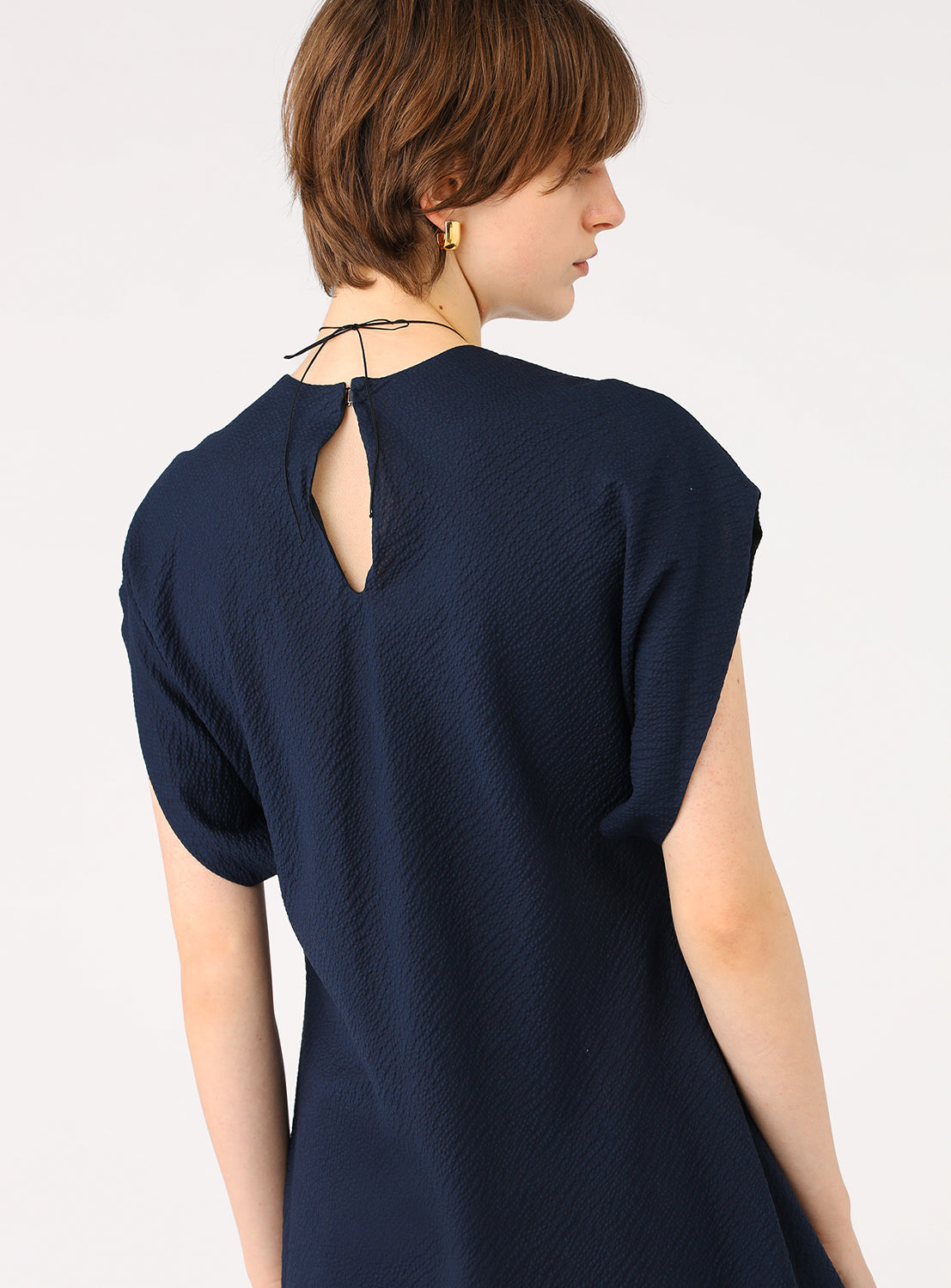 Close-up of the back of the dress showcasing the keyhole back design.