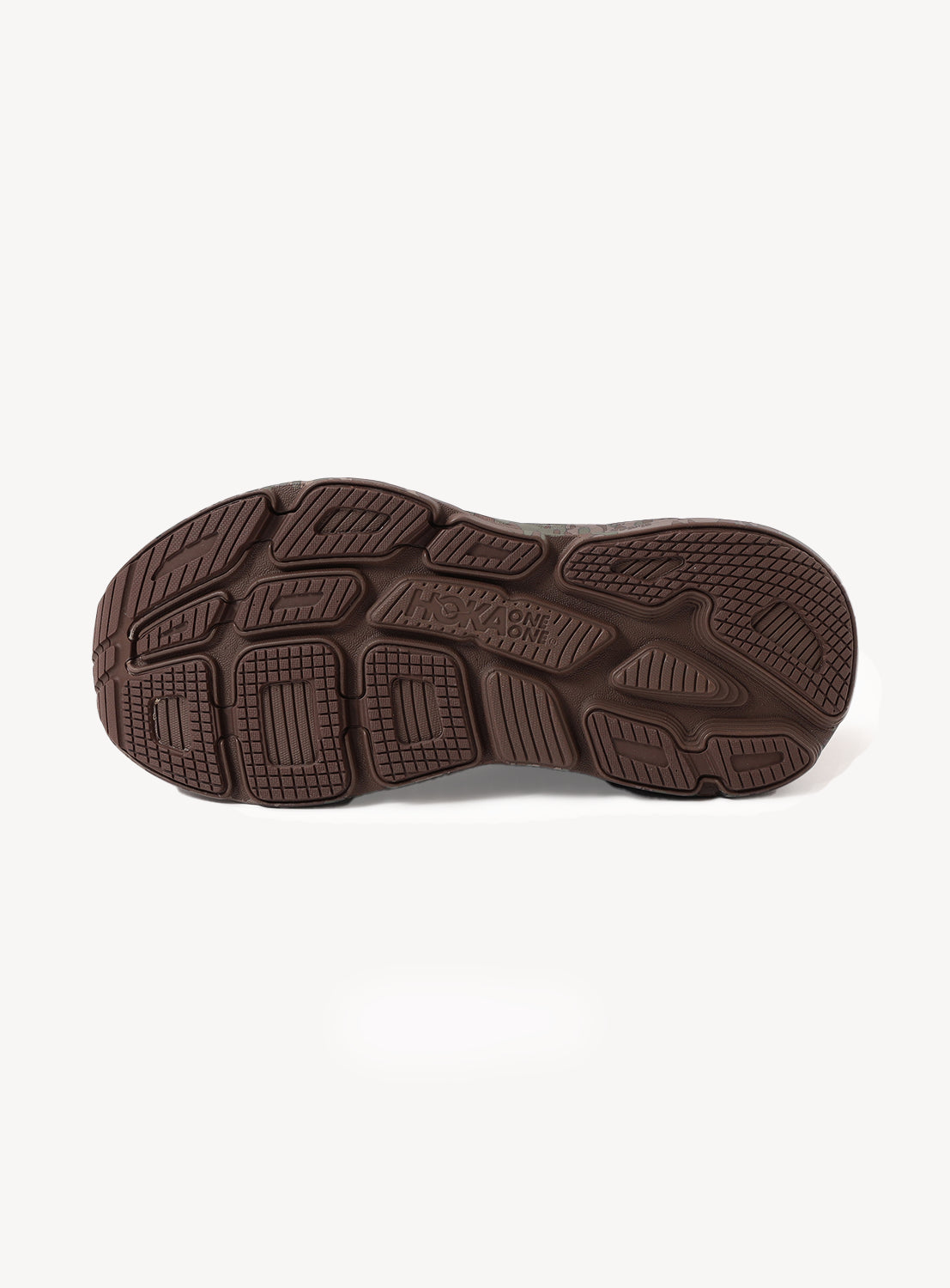 The image shows the brown textured sole of a Hoka U BONDI 7 BEAMS sneaker, viewed from the bottom, highlighting its tread pattern and grip design against a plain white background.
