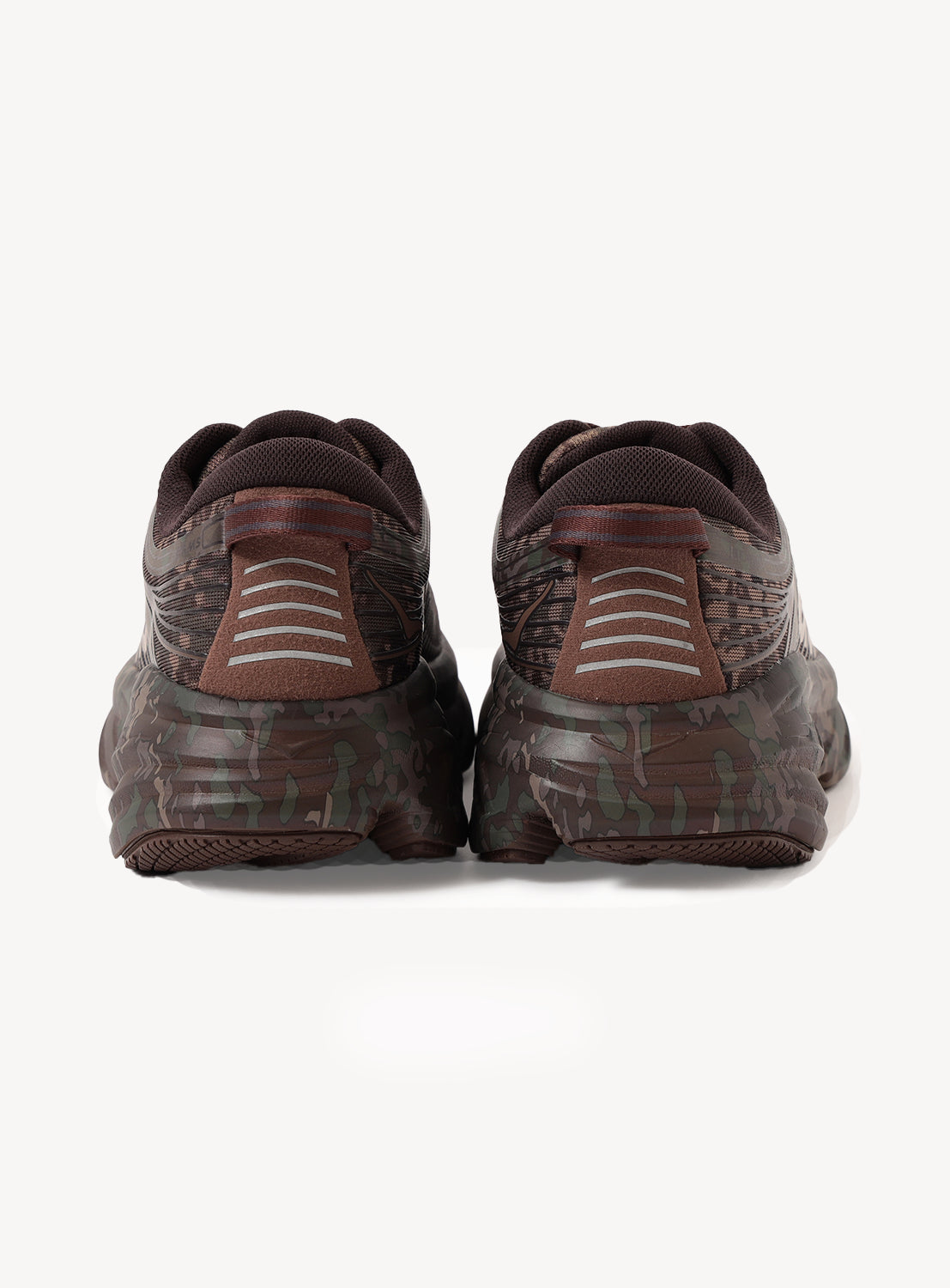 A pair of Hoka U BONDI 7 BEAMS sneakers in brown and green camo, seen from the back, featuring an engineered mesh upper and reflective heel stripes for enhanced visibility.