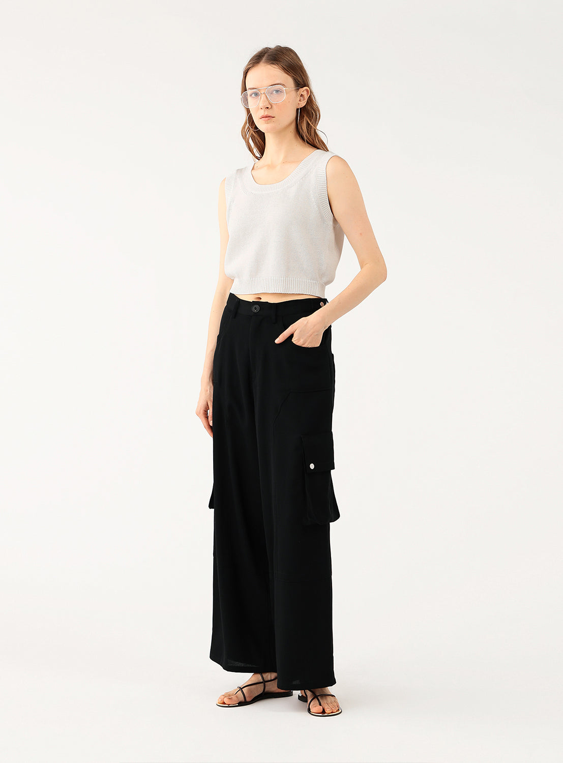 Model demonstrating a styled look, pairing the cream knit top with a long, flowing black skirt.
