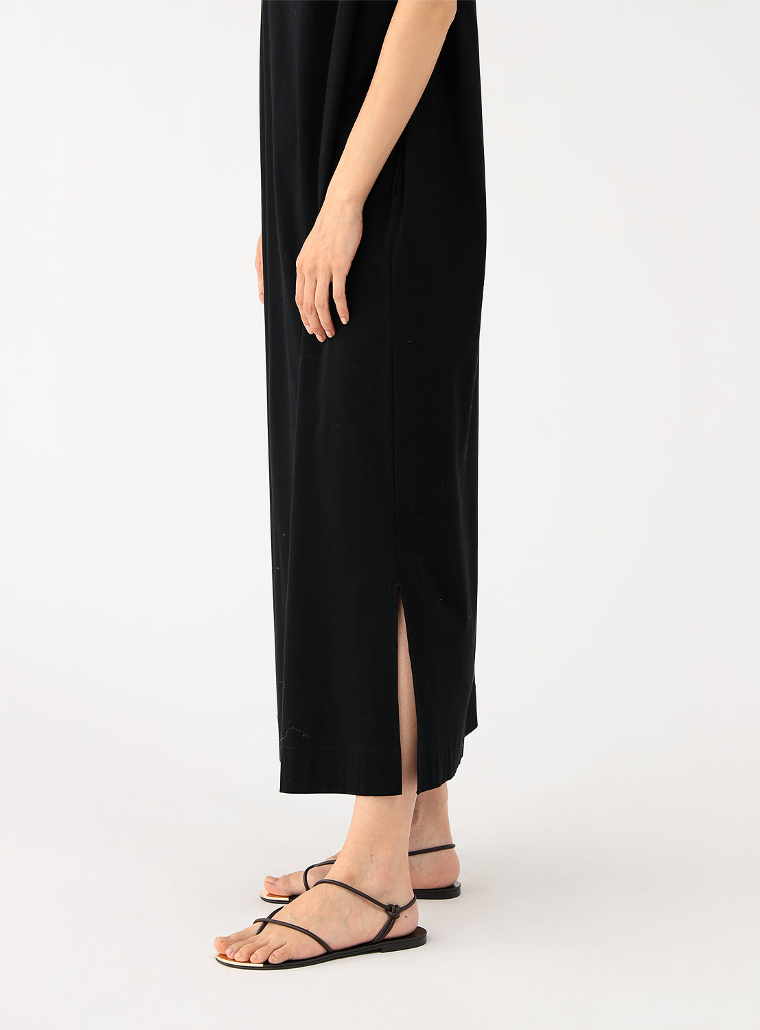 Close up of the bottom of the dress highlighting the calf-length side slit.