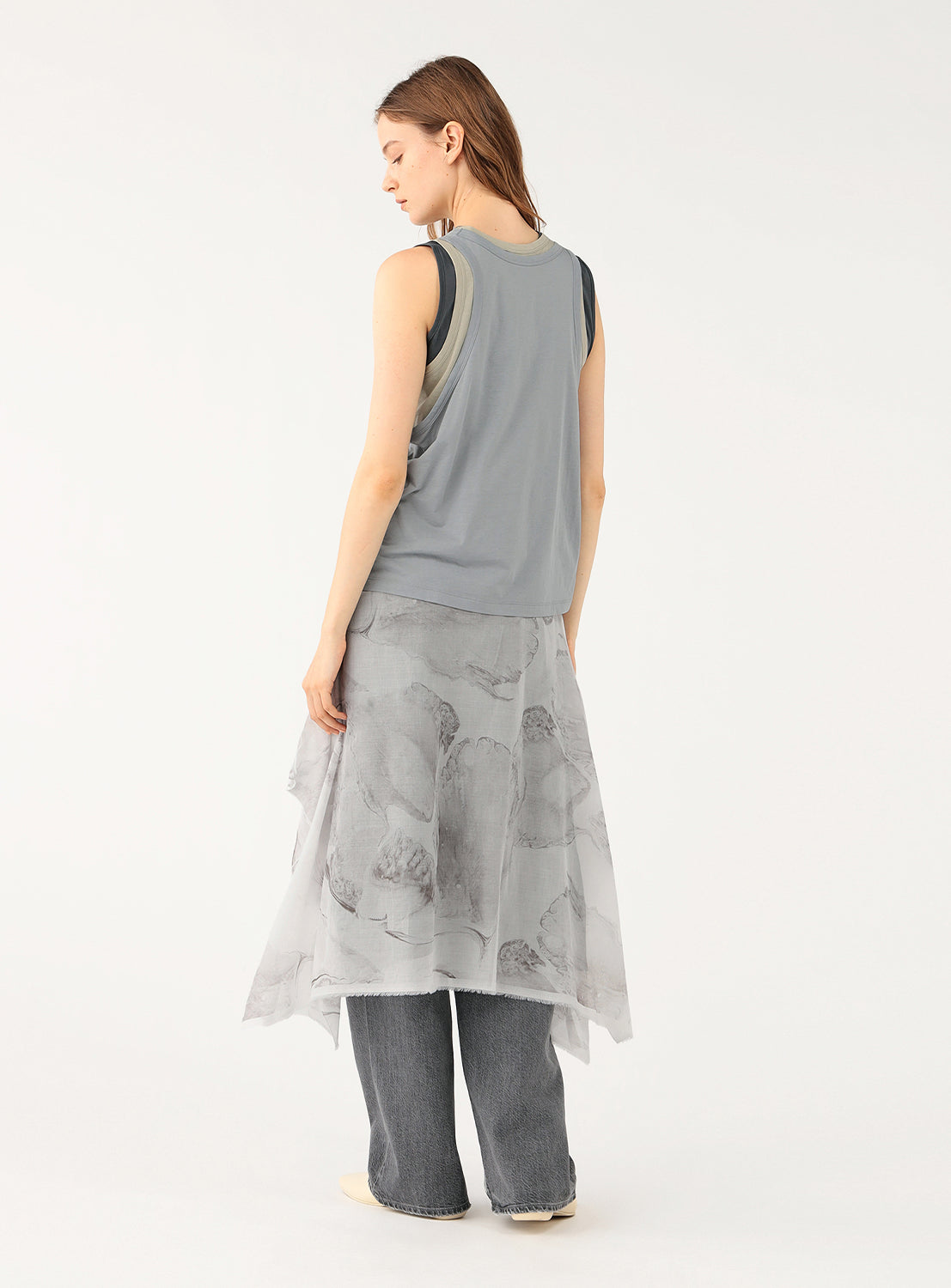 Back view of a model wearing a gray layered sleeveless top.