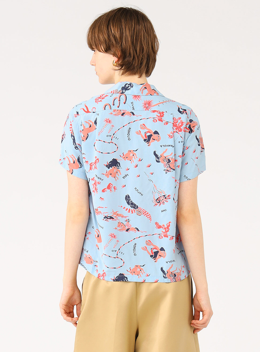 Back view of a model in the light blue patterned shirt, showing the full design and relaxed fit.