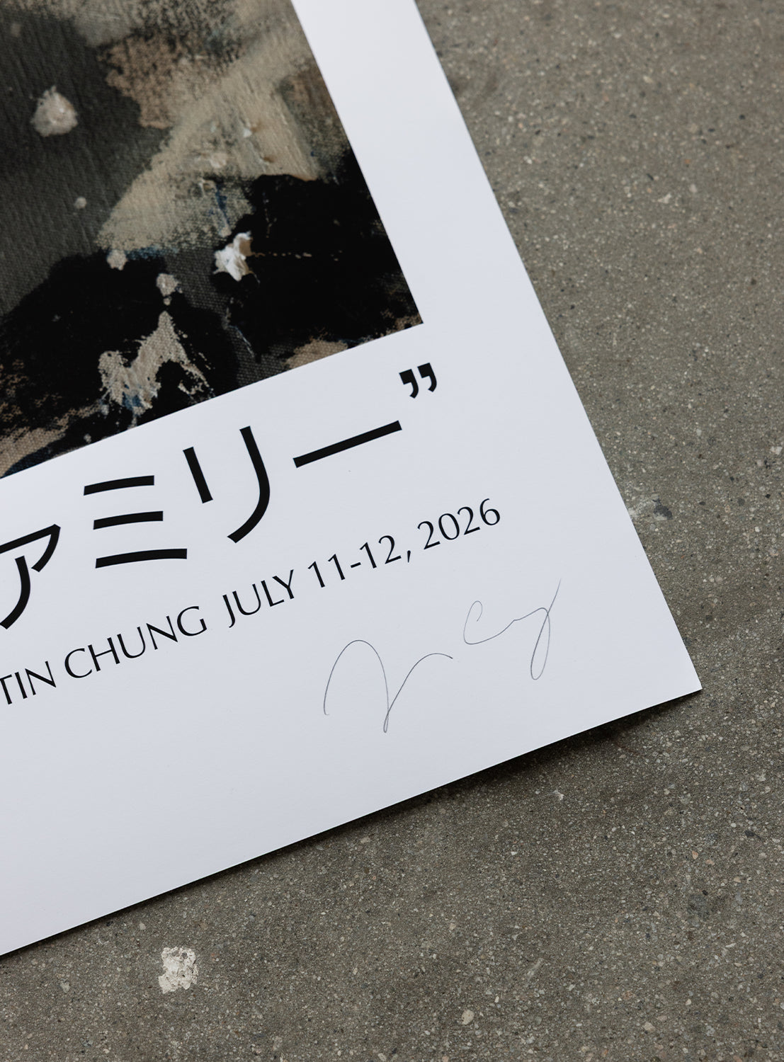 A close-up of the corner of the J. BRIAN x BEAMS POSTER 1 by BEAMS AMERICA on a gray surface, featuring Japanese text, English text with JULY 11-12, 2026, and a faint signature on the white border—highlighting this as an exclusive sneaker 50th anniversary edition inspired by Jereme Brian Mendez artwork.