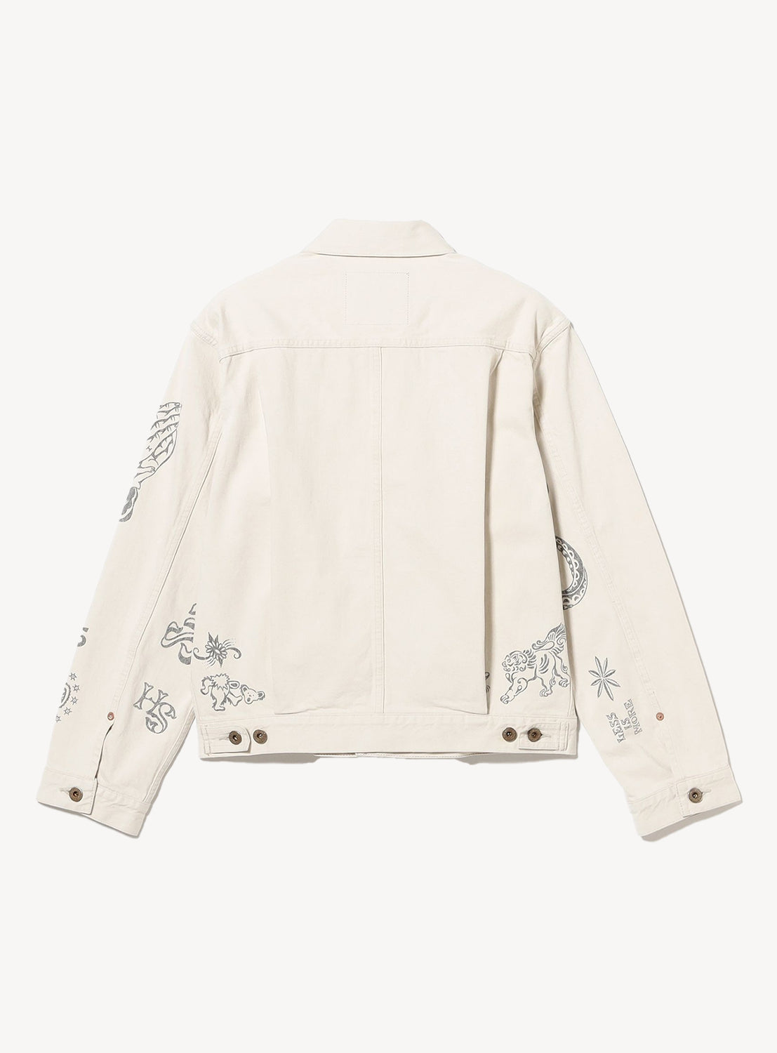 The SUGARHILL Tattoo Flash Print Denim Jacket is cream-colored and features black tattoo flash artwork with abstract shapes, animals, and small graphic details on the sleeves and lower back.