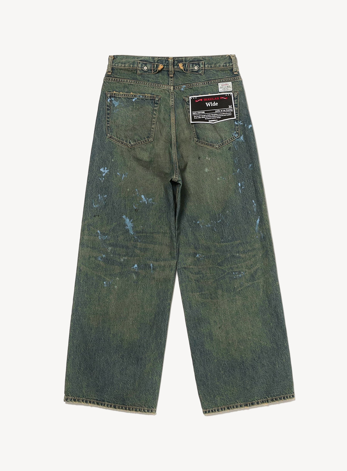 The "Paint" Wide Denim Pants by DAIRIKU feature a vintage-inspired wide-leg silhouette in a greenish-blue wash, designed with back pockets, paint splatters, and a black patch over one pocket that reads “Wide.” Shown laid flat on their back side against a white background.