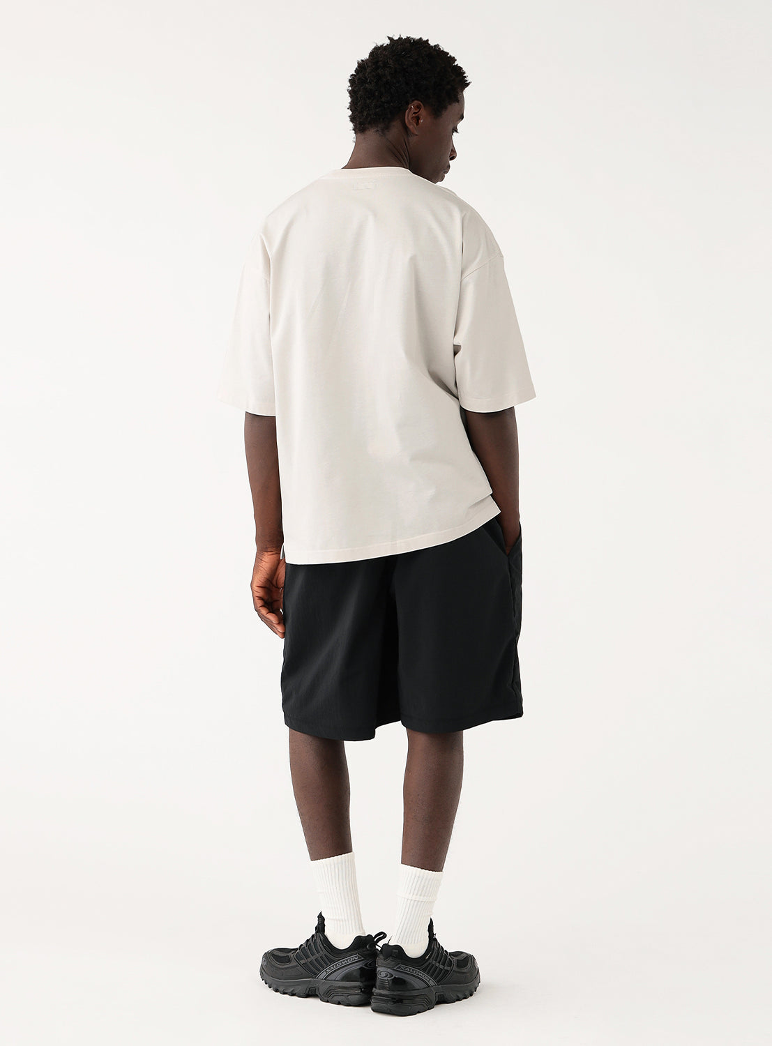 Back view of model wearing oyster color t-shirt