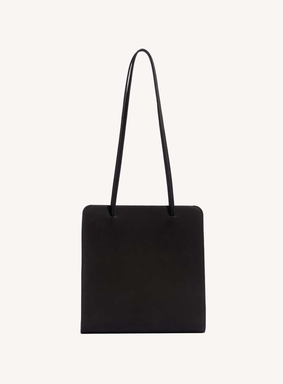 Black square handbag with long, ribbon-like straps.