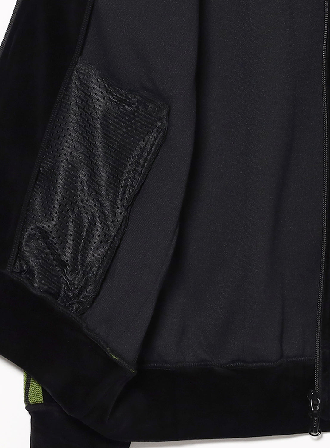 Close-up of the inside of a black jacket with a textured pocket and zipper detail.