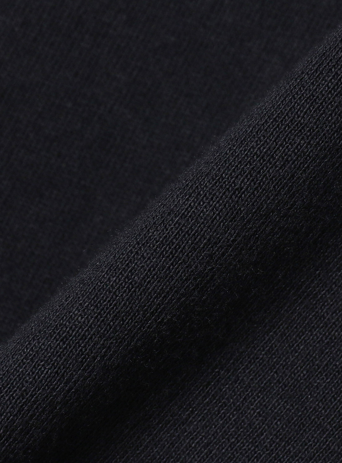 Close-up of navy t-shirt fabric, detailing the soft texture and high-quality material.