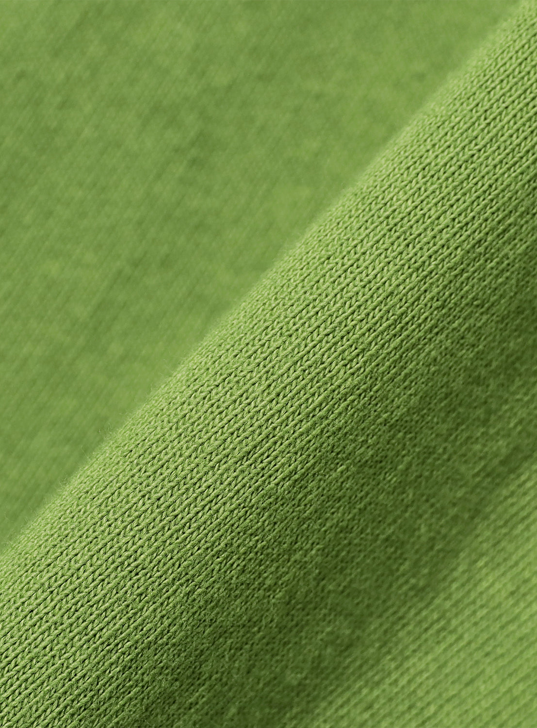 Close-up of kelly green t-shirt fabric, detailing the soft texture and high-quality material.