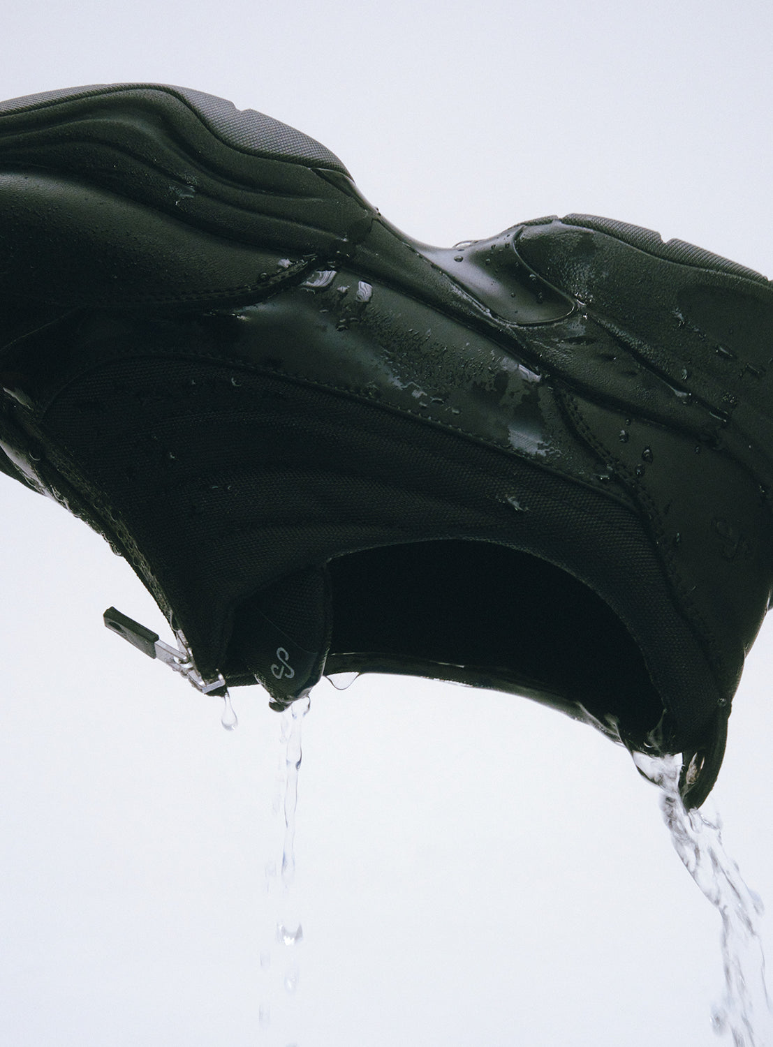 Close-up of OAO FOUNTAIN waterproof sneaker showing water-resistant material