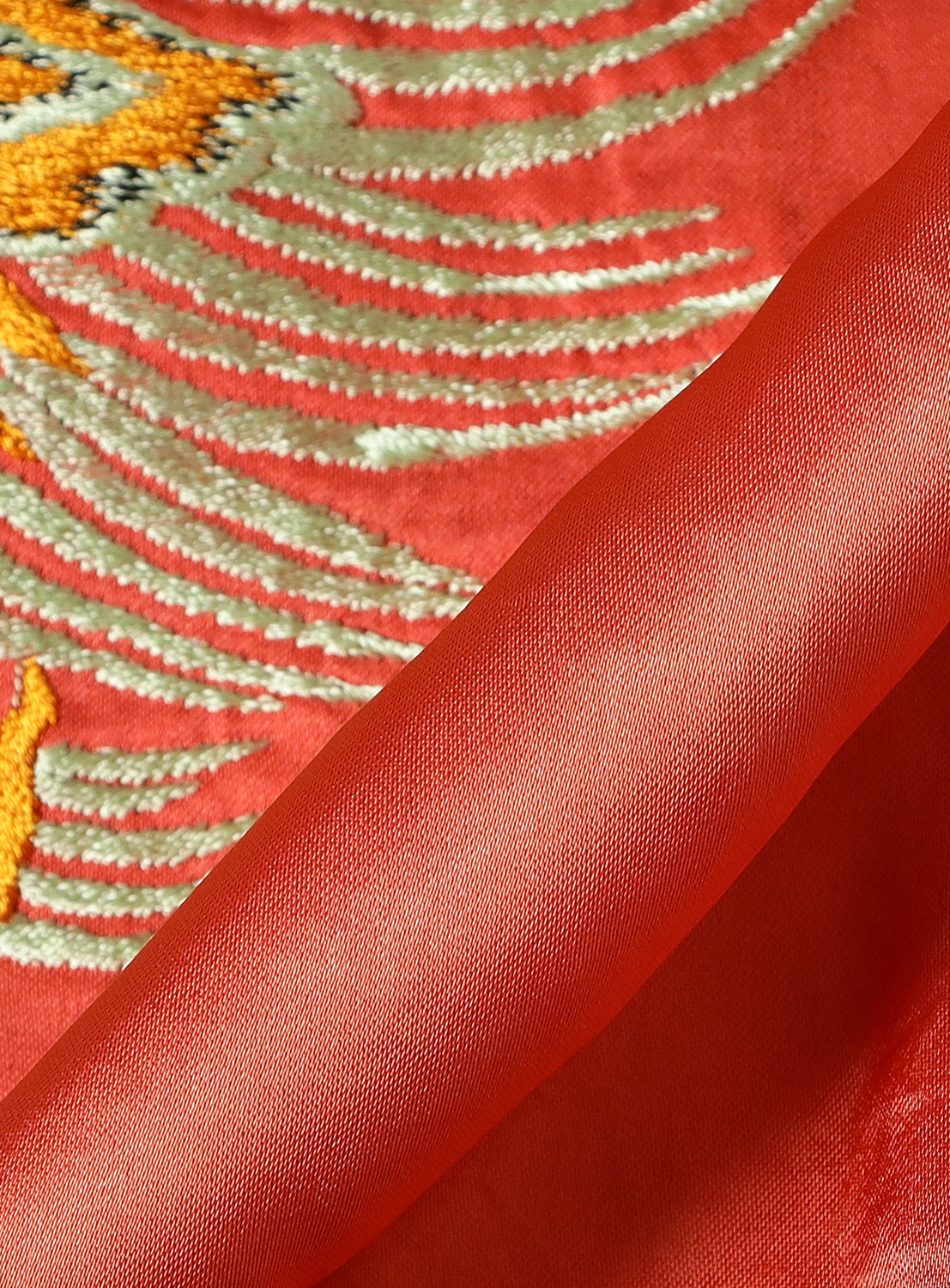 Close-up of the TAILOR TOYO Late 1940s Style Acetate Souvenir Jacket KOSHO & CO. Special Edition “EAGLE & DRAGON” × “JAPAN MAP,” showing red satin with gold and white Japanese embroidery and a neatly folded edge in the foreground.