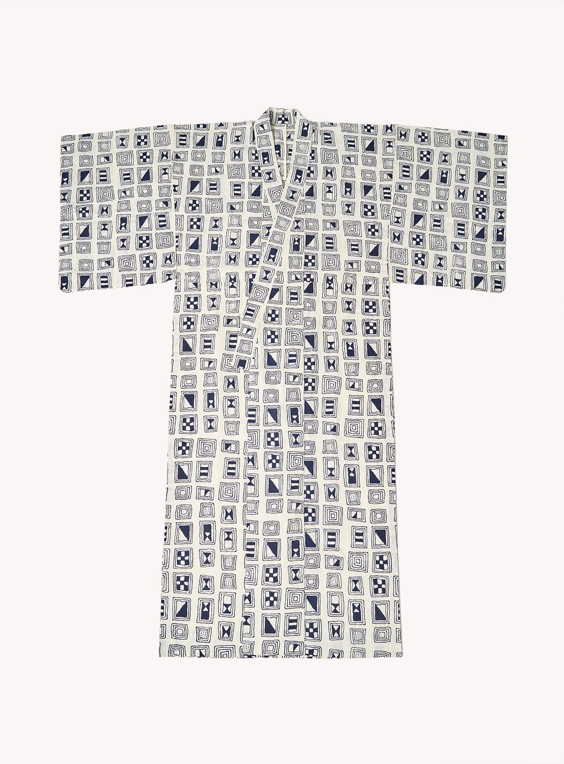 The Tutaee Men’s Yukata, crafted from soft cotton by the brand Tutaee, is a traditional Japanese garment featuring wide sleeves. This cotton yukata showcases a geometric pattern of blue and white squares with various abstract designs, all set against a plain white background.