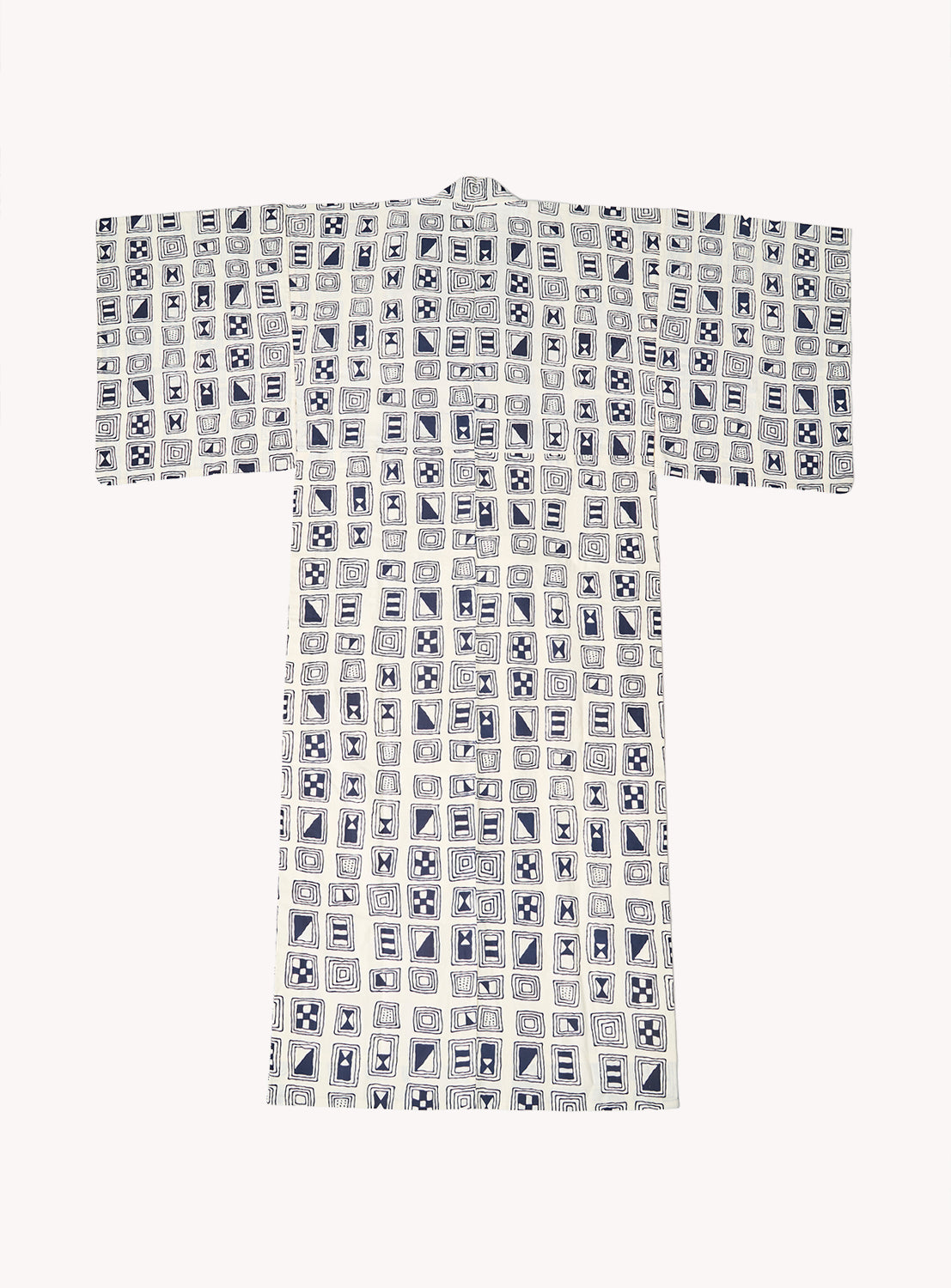 The Tutaee Men’s Yukata by Tutaee features a geometric grid pattern in blue and white, with squares filled with abstract and floral designs. This traditional Japanese garment is made of light, smooth cotton and has wide sleeves.