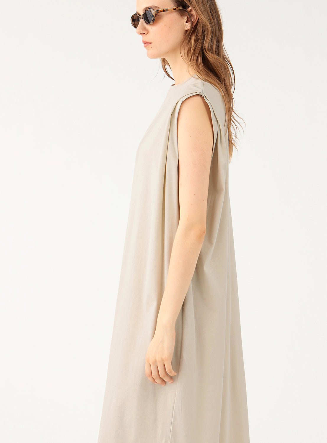 Close-up of a model wearing a light grey midi dress, focusing on the neckline.