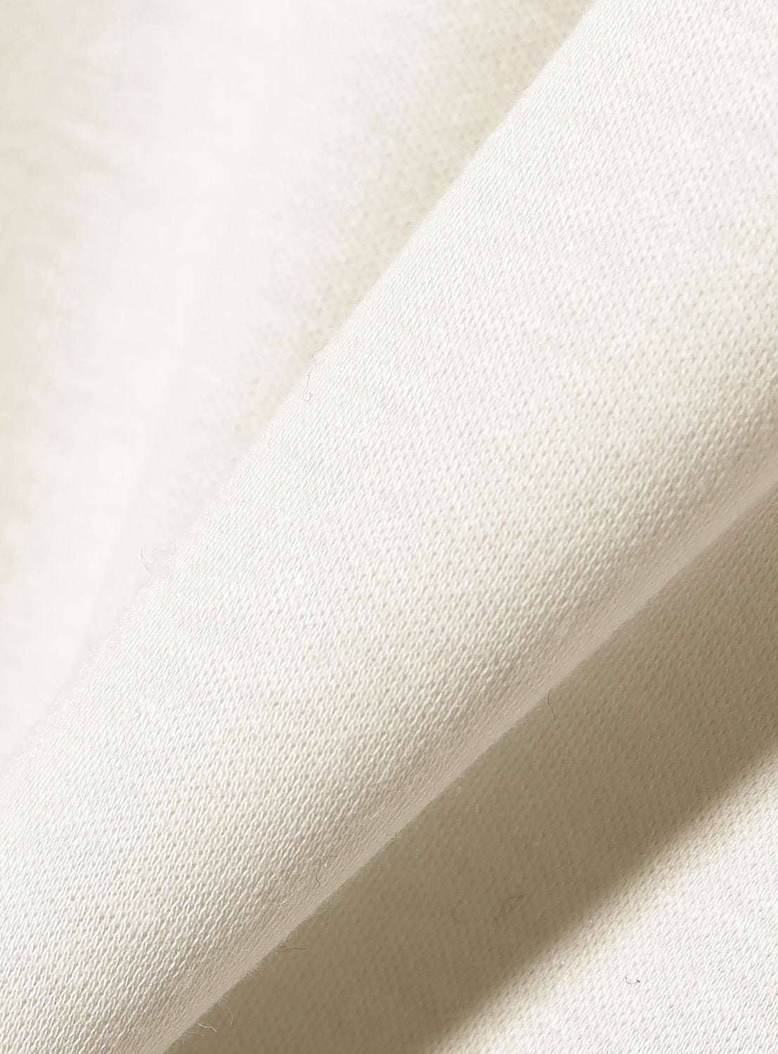 Close-up of the material, highlighting the quality and subtle texture of the dress fabric.