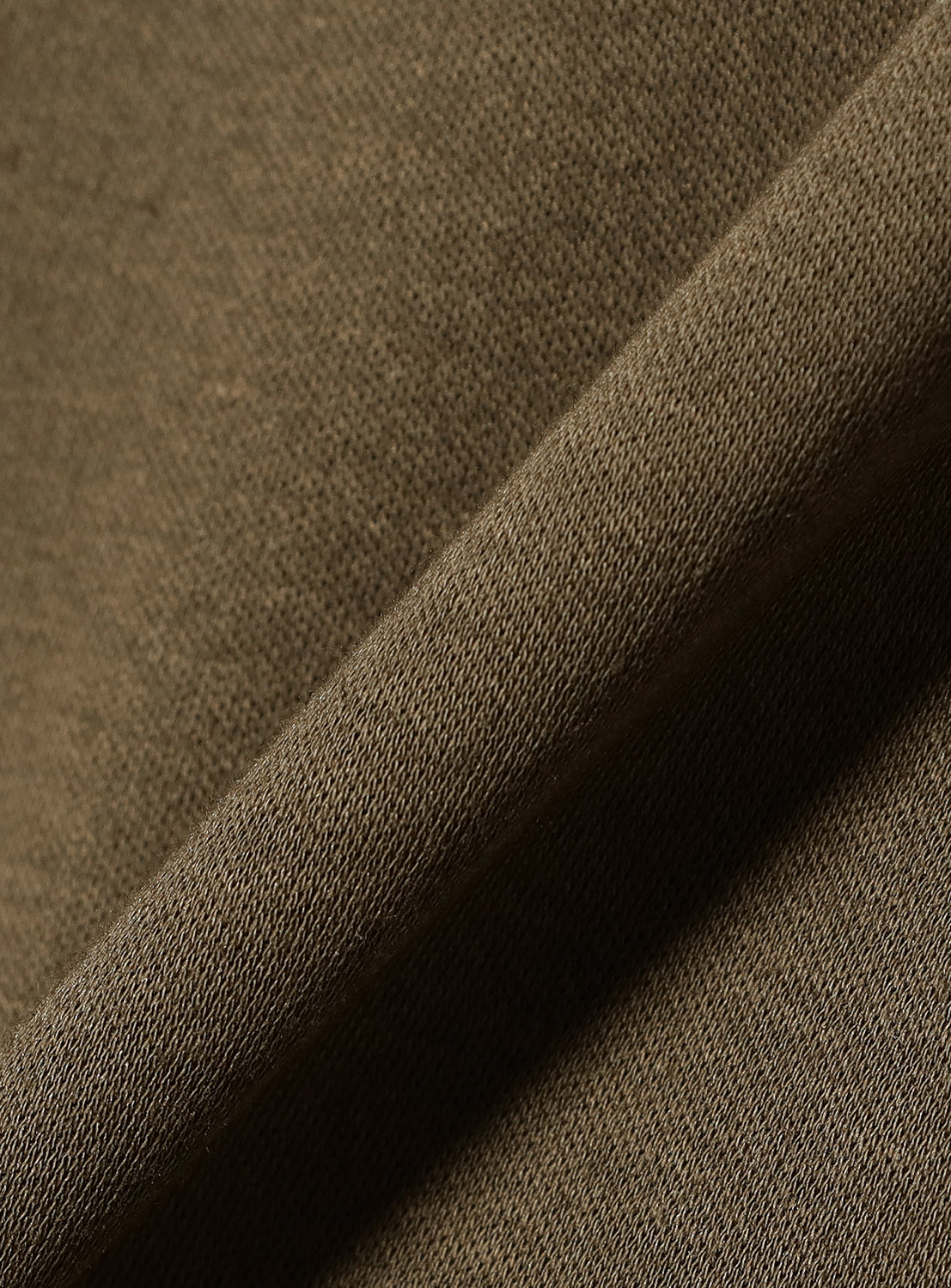 Close-up of the khaki material, highlighting the soft texture and color of the dress fabric.