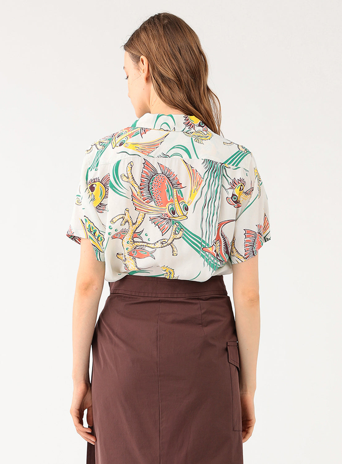 Back view of a model in the white patterned shirt, showing the full design and relaxed fit.