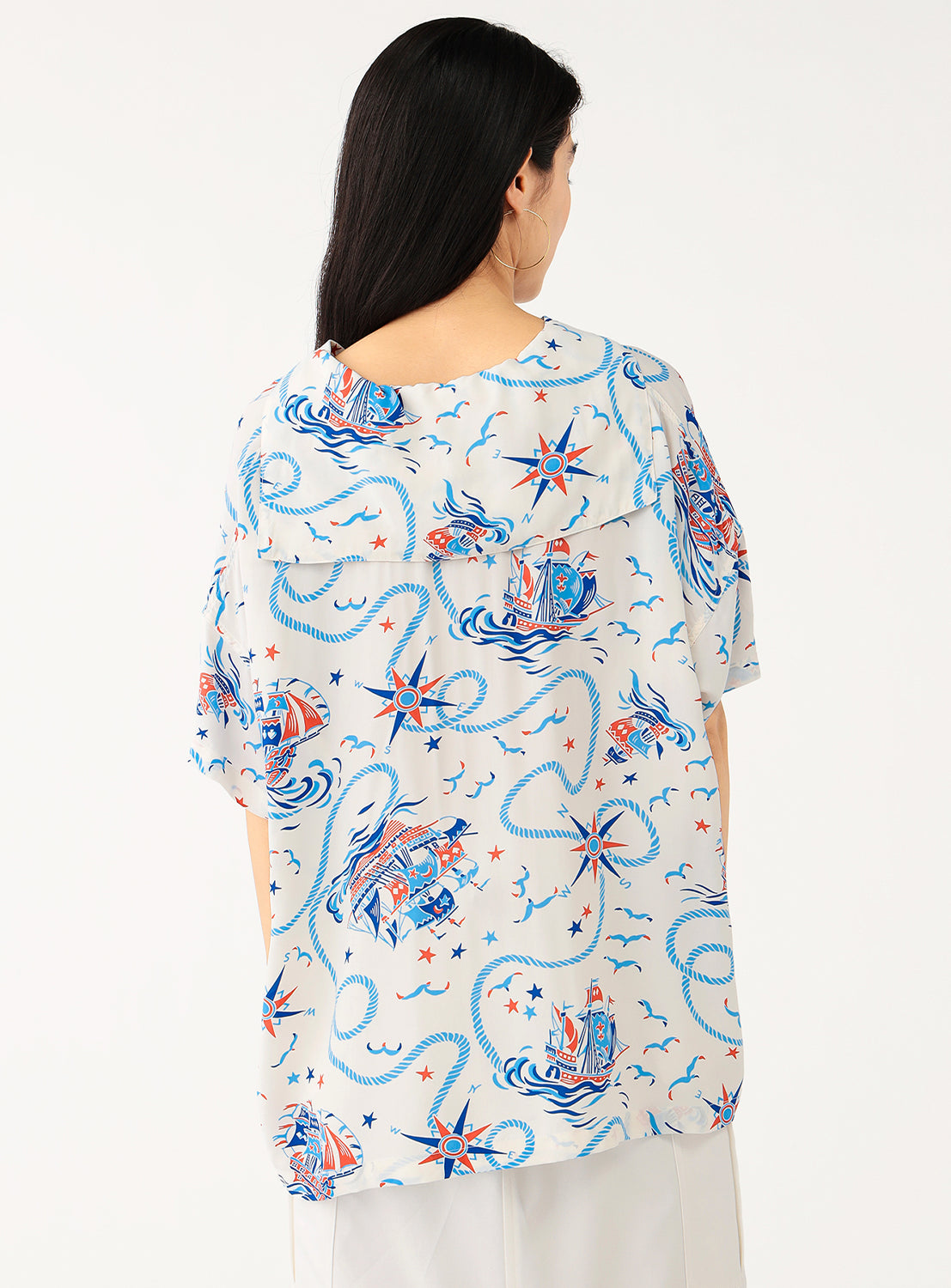 Back view of a model in the white patterned shirt, showing the full design and relaxed fit.