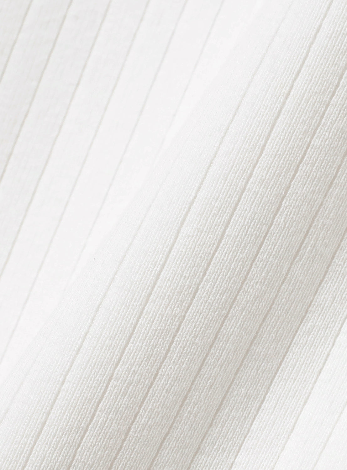 Close-up of white ribbed fabric texture.