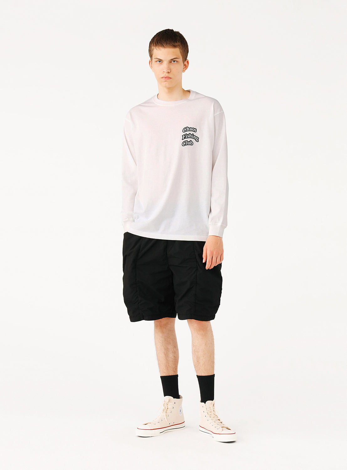 Model wearing TEATORA shorts, showcasing a sleek design with hidden compartments for travel.
