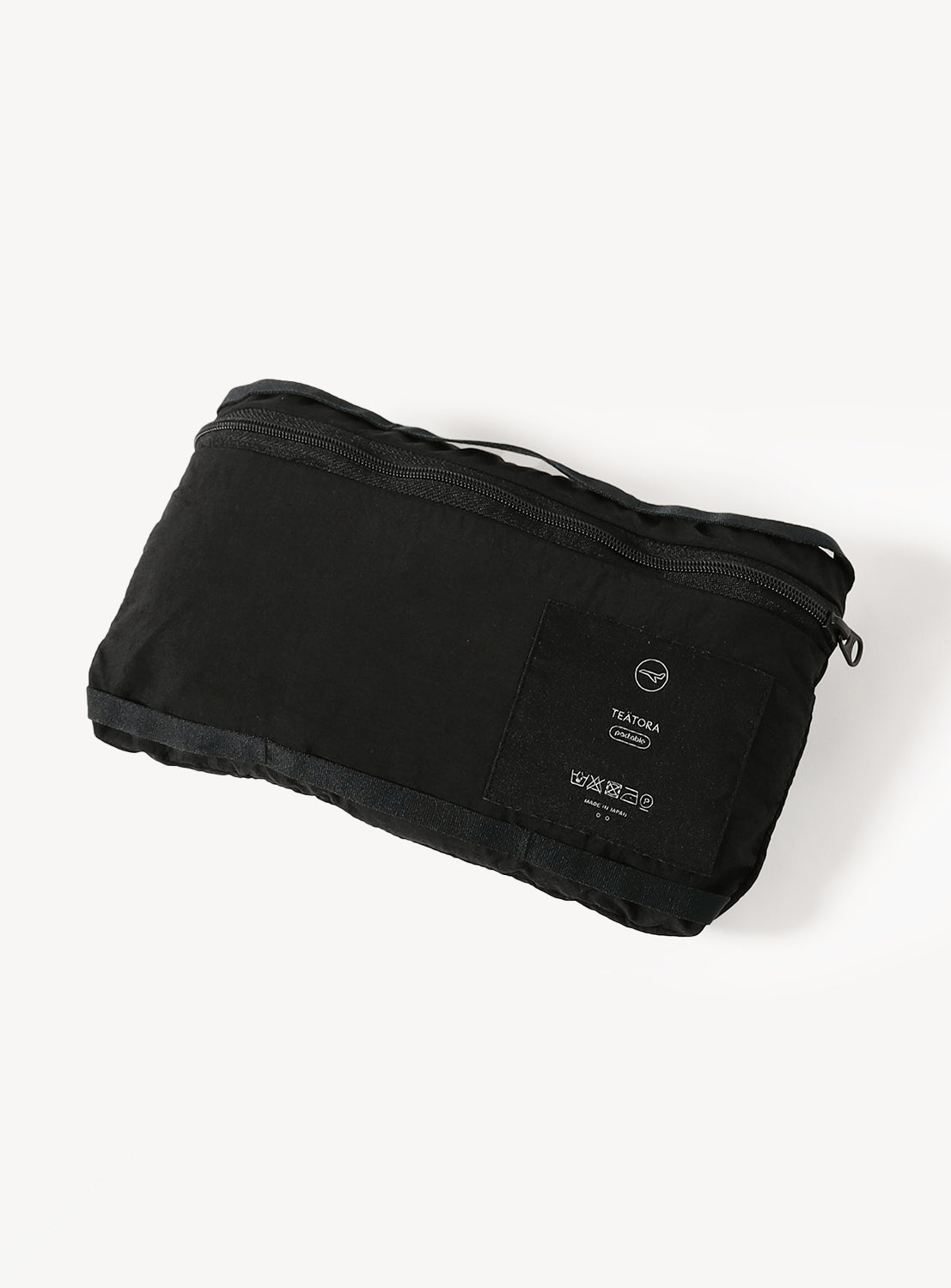 Close-up of the black shorts folded and packed into the integrated Security Pouch for travel.