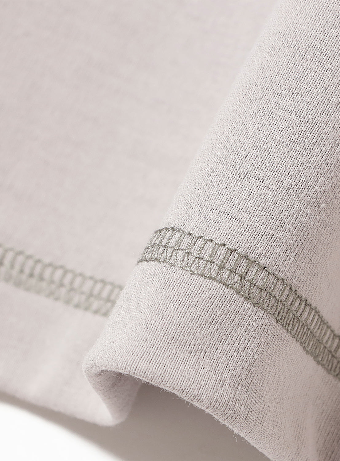 Close-up of a t-shirt fabric and stitching detail. 