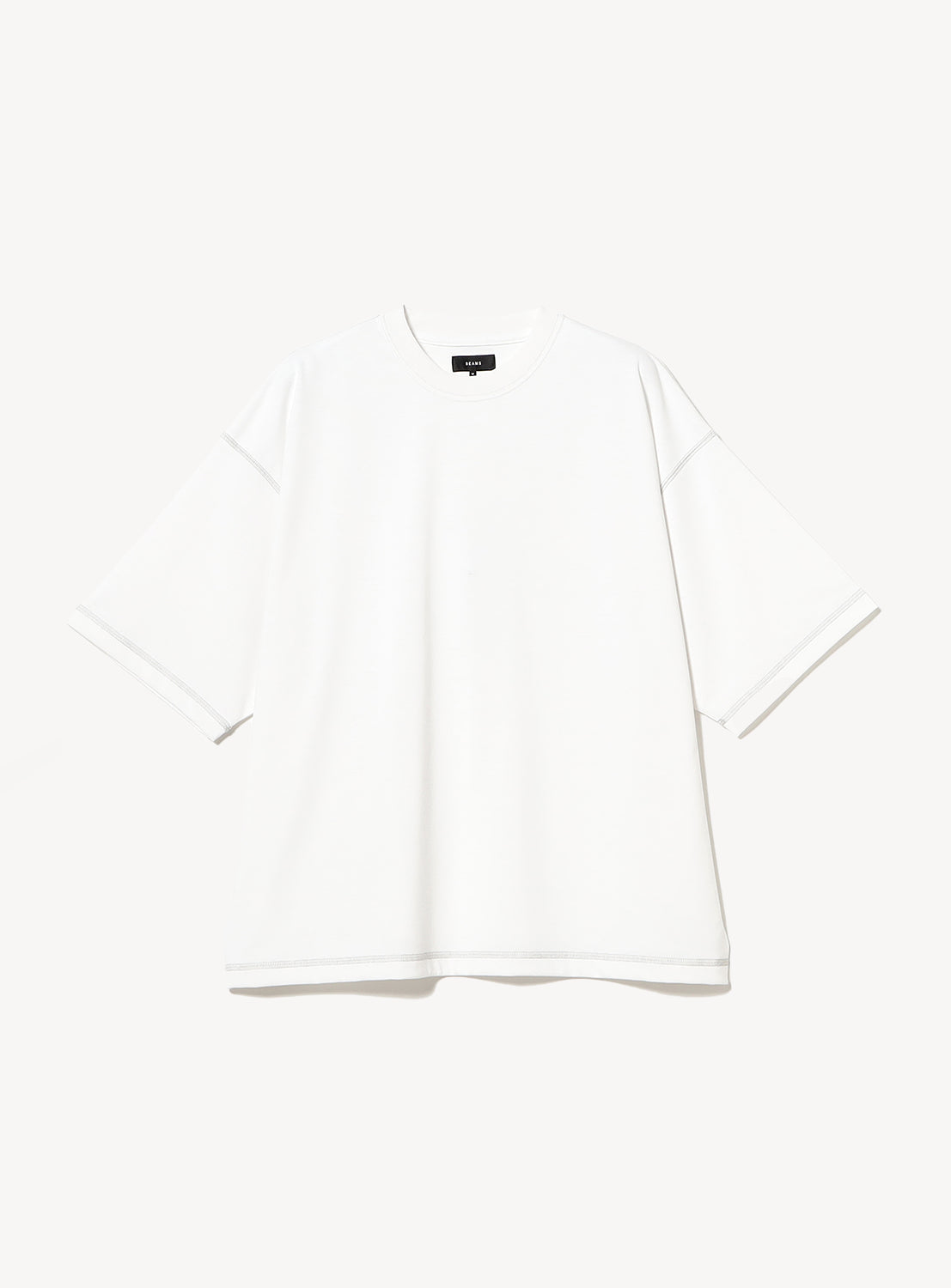 White t-shirt with stitching details. 