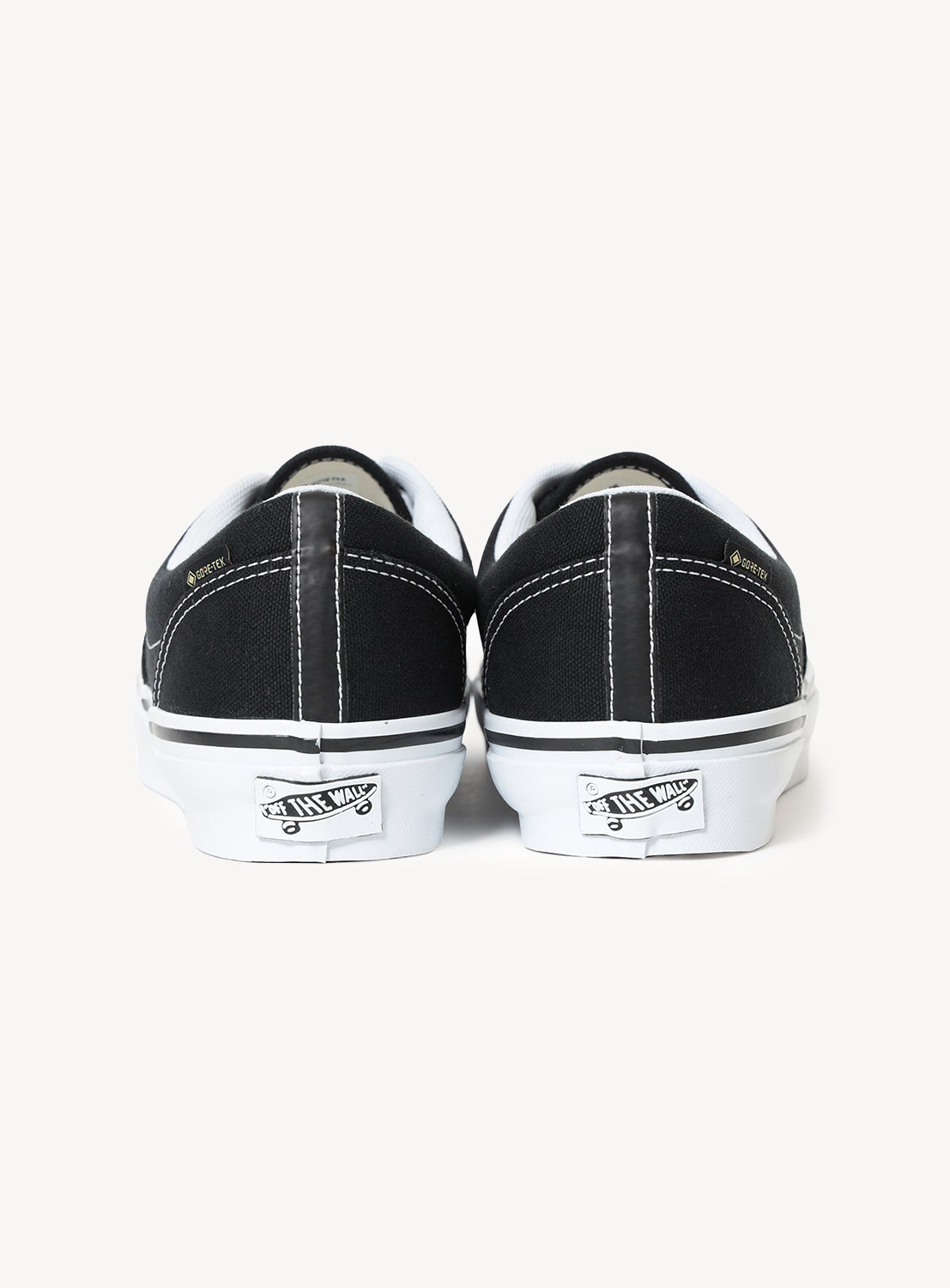 Black and white sneakers with brand logo on a white background