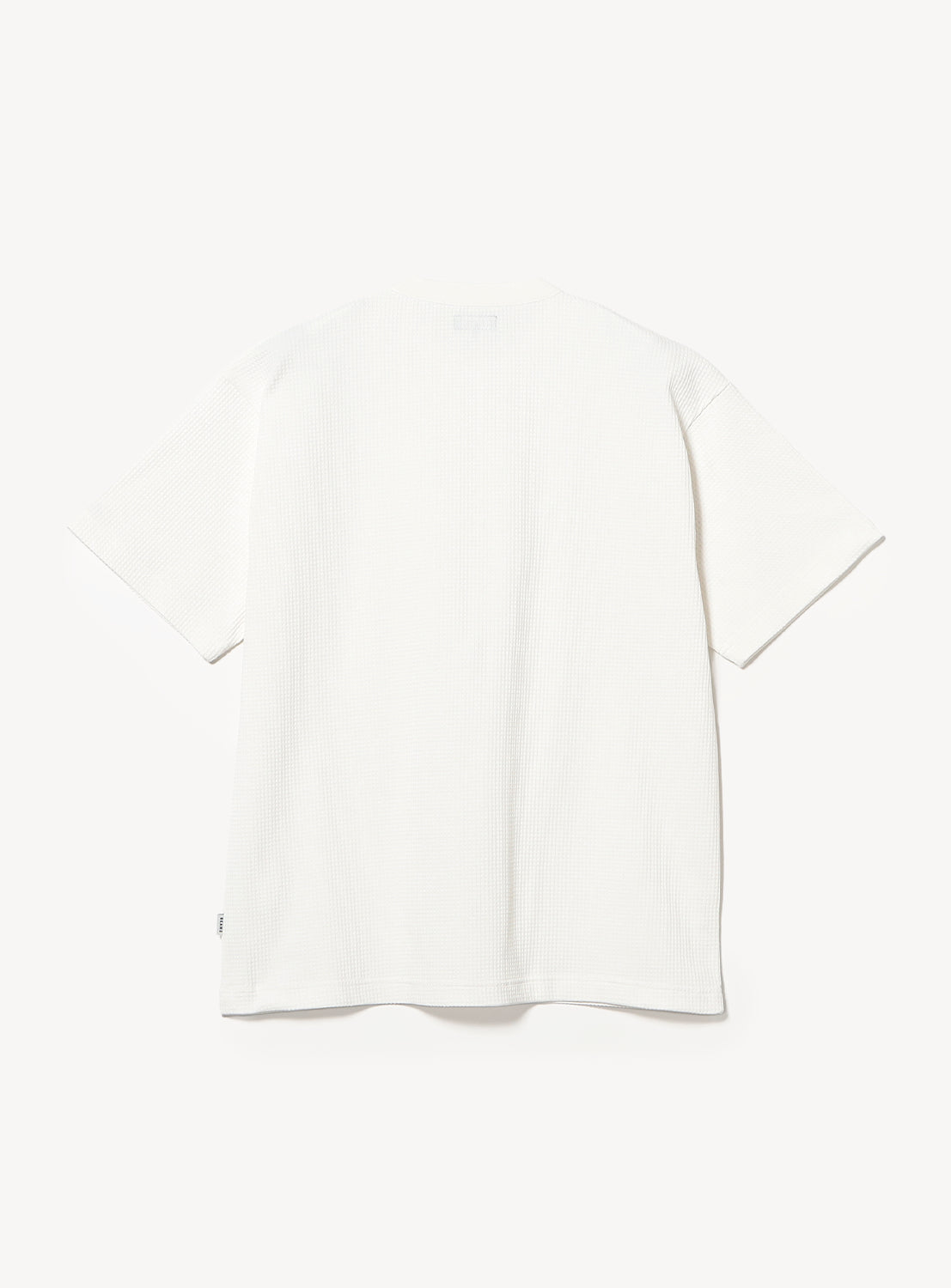A BEAMS Stretch Waffle T-Shirt in plain white, featuring short sleeves and a crew neck, is laid flat with the back side facing up against a white background.