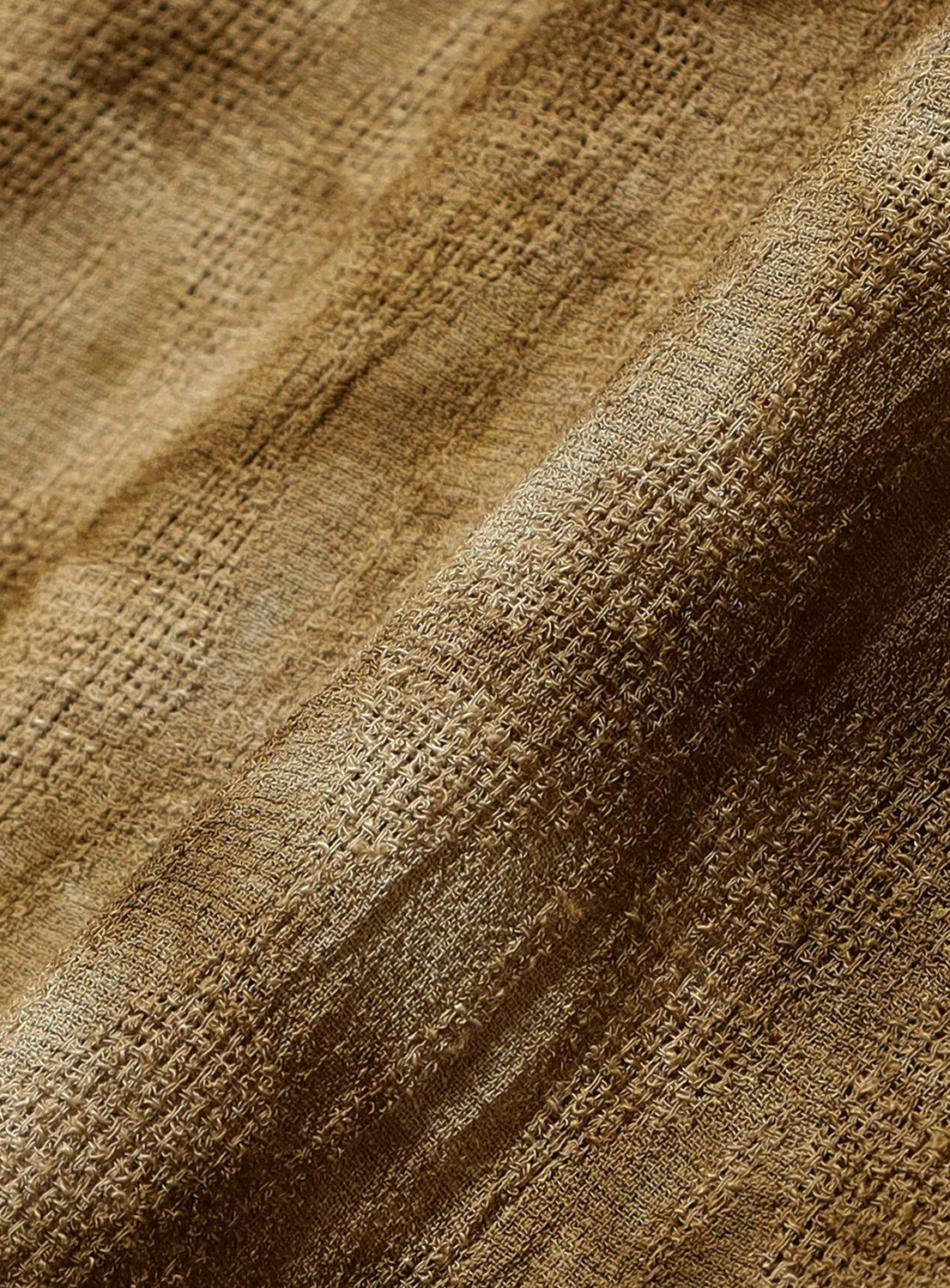 Close-up of textured brown fabric with visible weave pattern